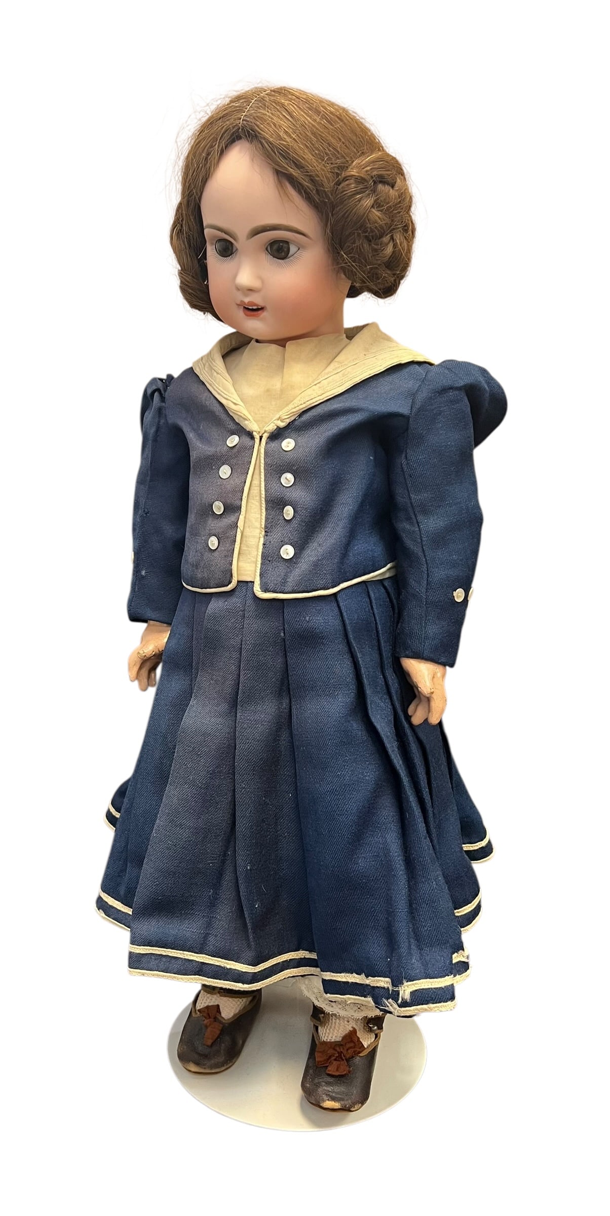 Vintage Germany Bisque Head Doll: This appears to be an antique bisque-head doll wearing a traditional blue sailor-style outfit. [1, 2]Key FeaturesHead: Crafted from painted bisque porcelain with detailed facial features and fixed
