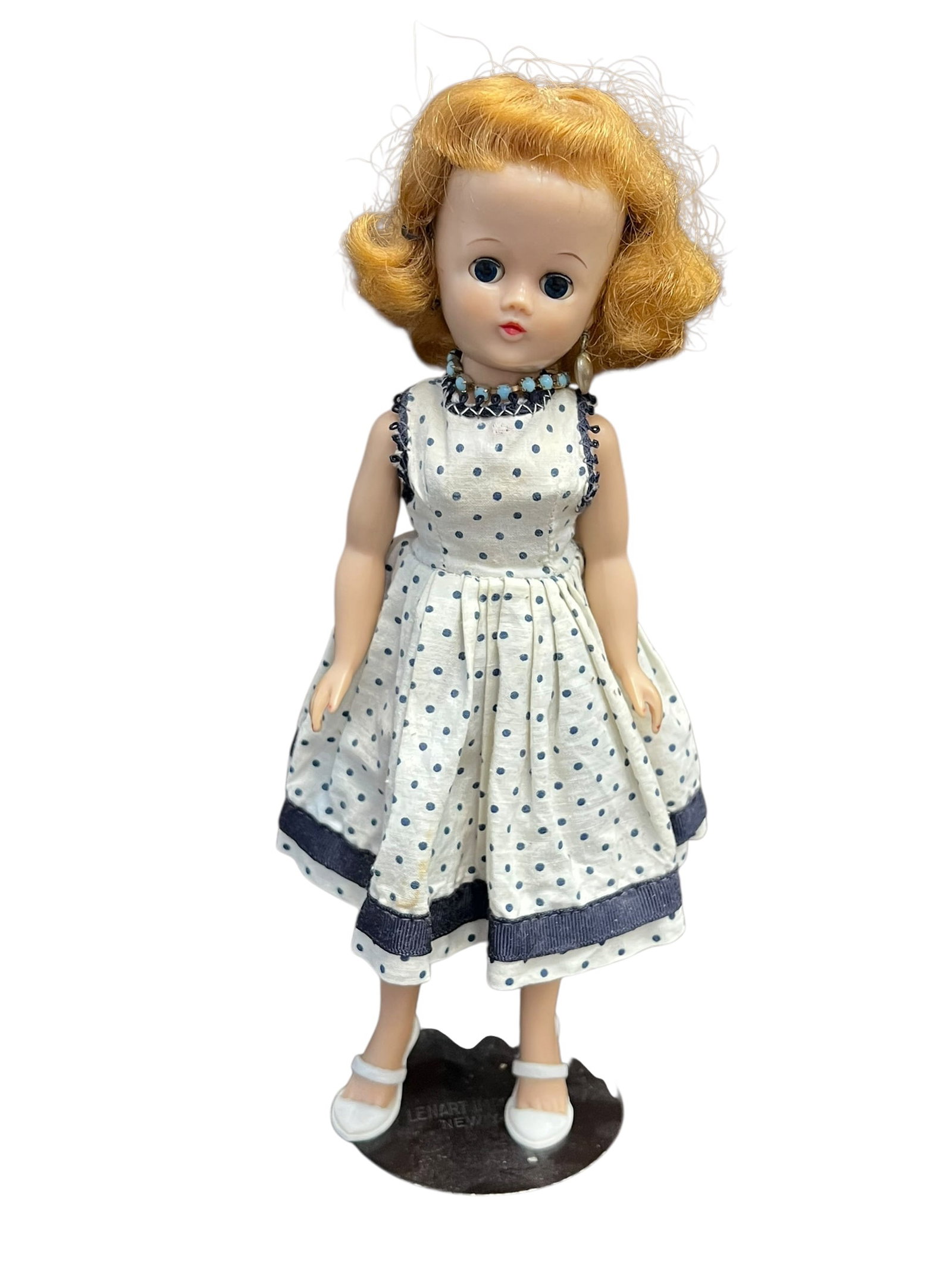 Vogue Vinyl Doll: vintage 1950s fashion doll, specifically matching the design of the Miss Ginger doll produced by the Cosmopolitan Doll and Toy Corporation.Key Characteristics & Identification Features:Era: Circa