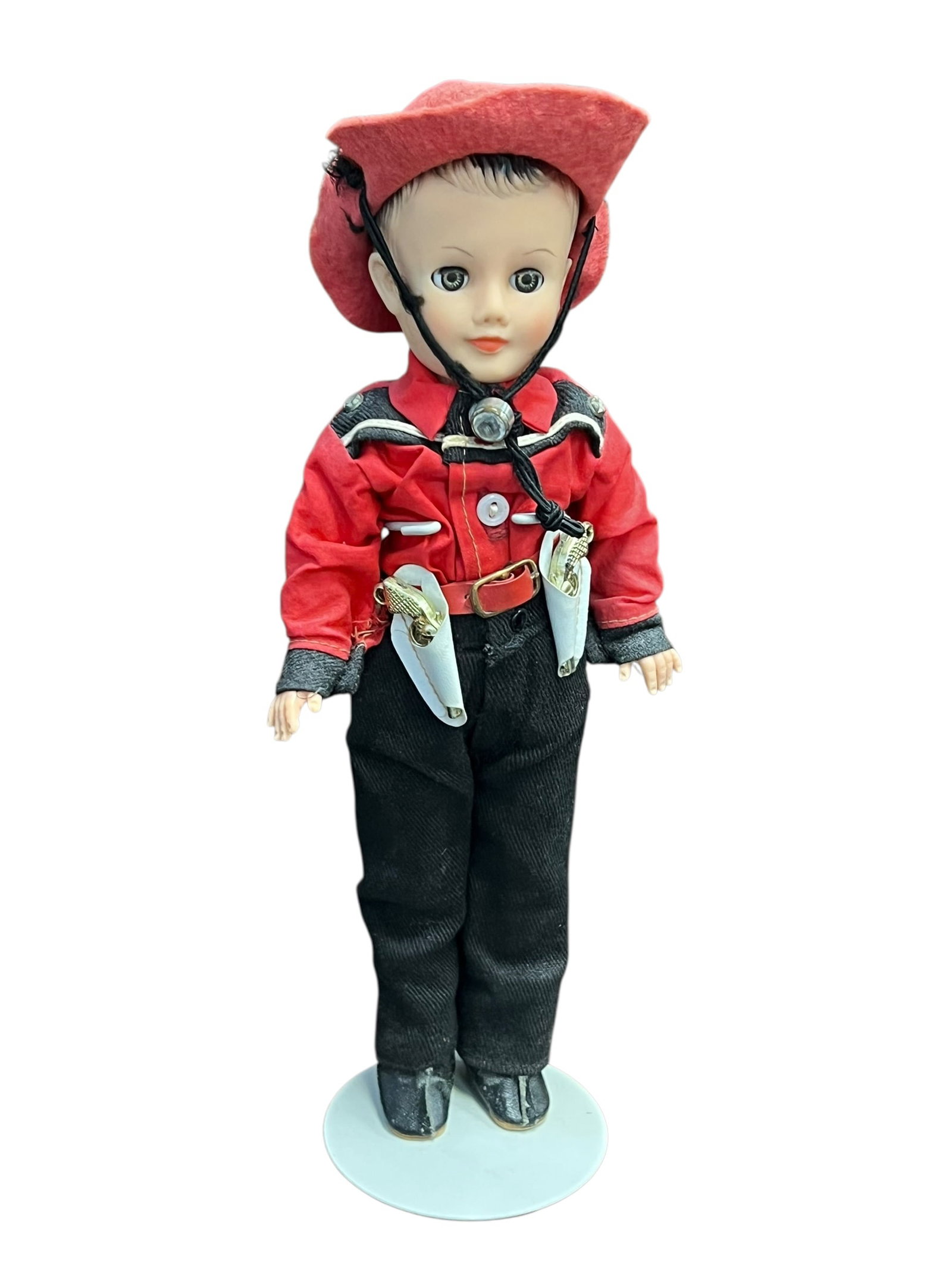 Vogue Vinyl Doll: This is a vintage hard plastic cowboy doll, a collectible toy likely manufactured during the mid-20th century (circa 1950s–1960s).It features classic details popular for western-themed character dol