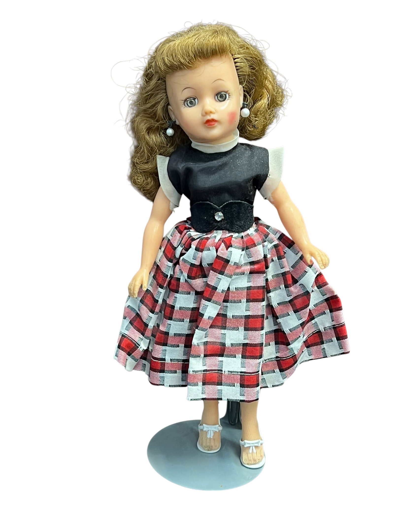 Ideal Vinyl Doll: vintage vinyl fashion doll from the late 1950s, which strongly resembles an Ideal Little Miss Revlon or similar teen fashion doll wearing a red, black, and white plaid skirt outfit with a black