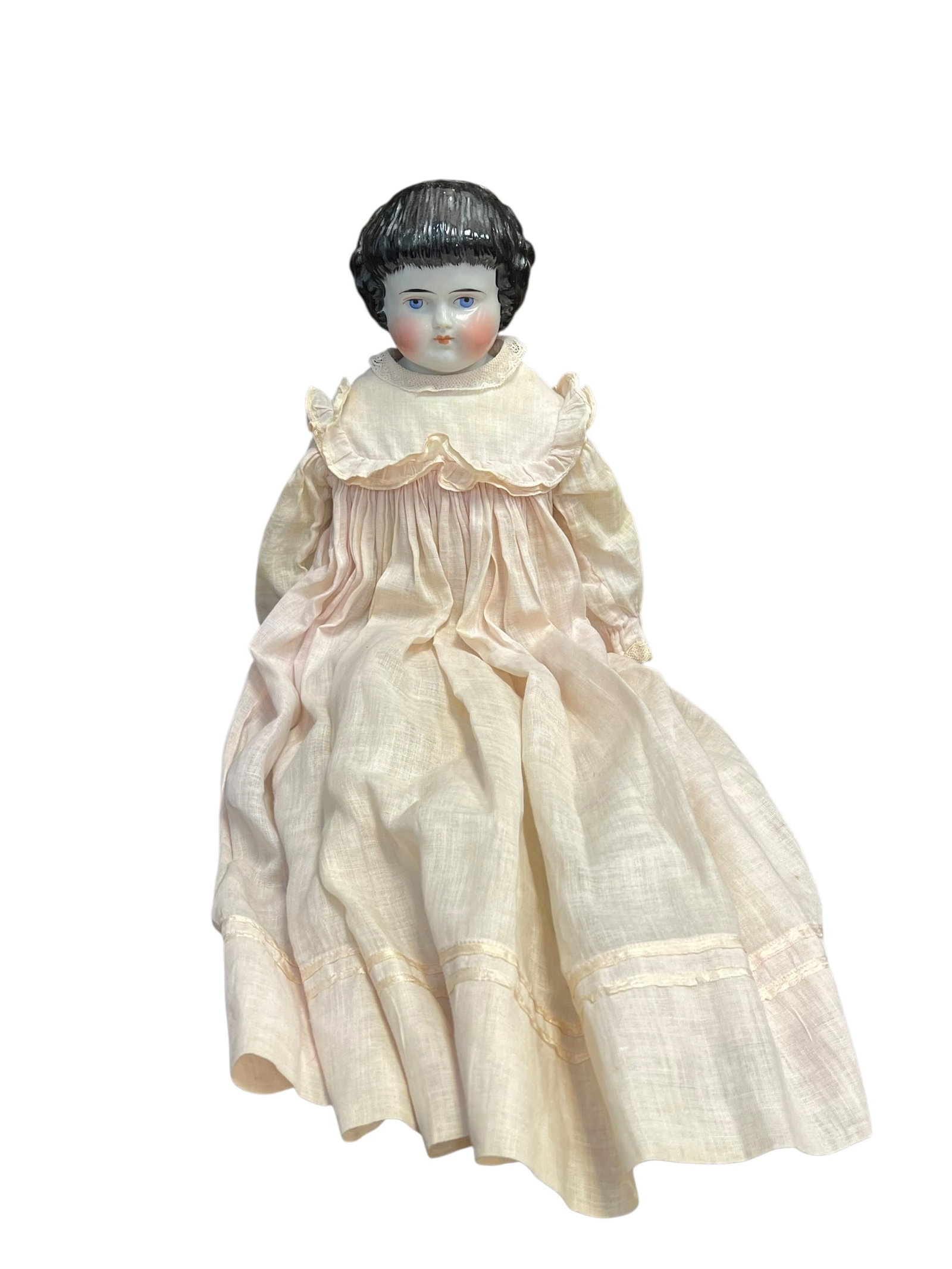 China Head Doll: antique German china head doll from the late 19th or early 20th century, featuring a glazed porcelain shoulder head, painted facial features with blue eyes, molded black hair, and a fabric-stuffed