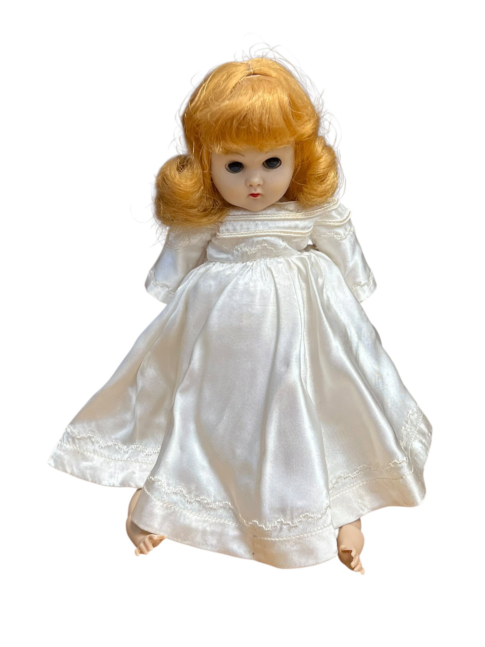 Vogue “Ginny?? Doll: This looks like a vintage 1950s-era hard plastic or vinyl doll, closely resembling classic Vogue Ginny or Madame Alexander mid-century designs.She is styled as either a bride or a First Communion doll