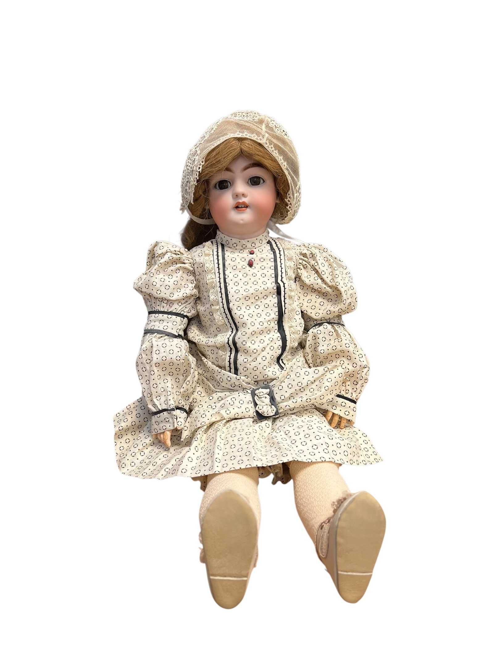 S&H DEP Bisque Head Doll: antique bisque head doll wearing a patterned dress and a matching bonnet. [1]Key FeaturesHead Material: Made of bisque porcelain, which has a matte, unglazed finish for a realistic skin-like