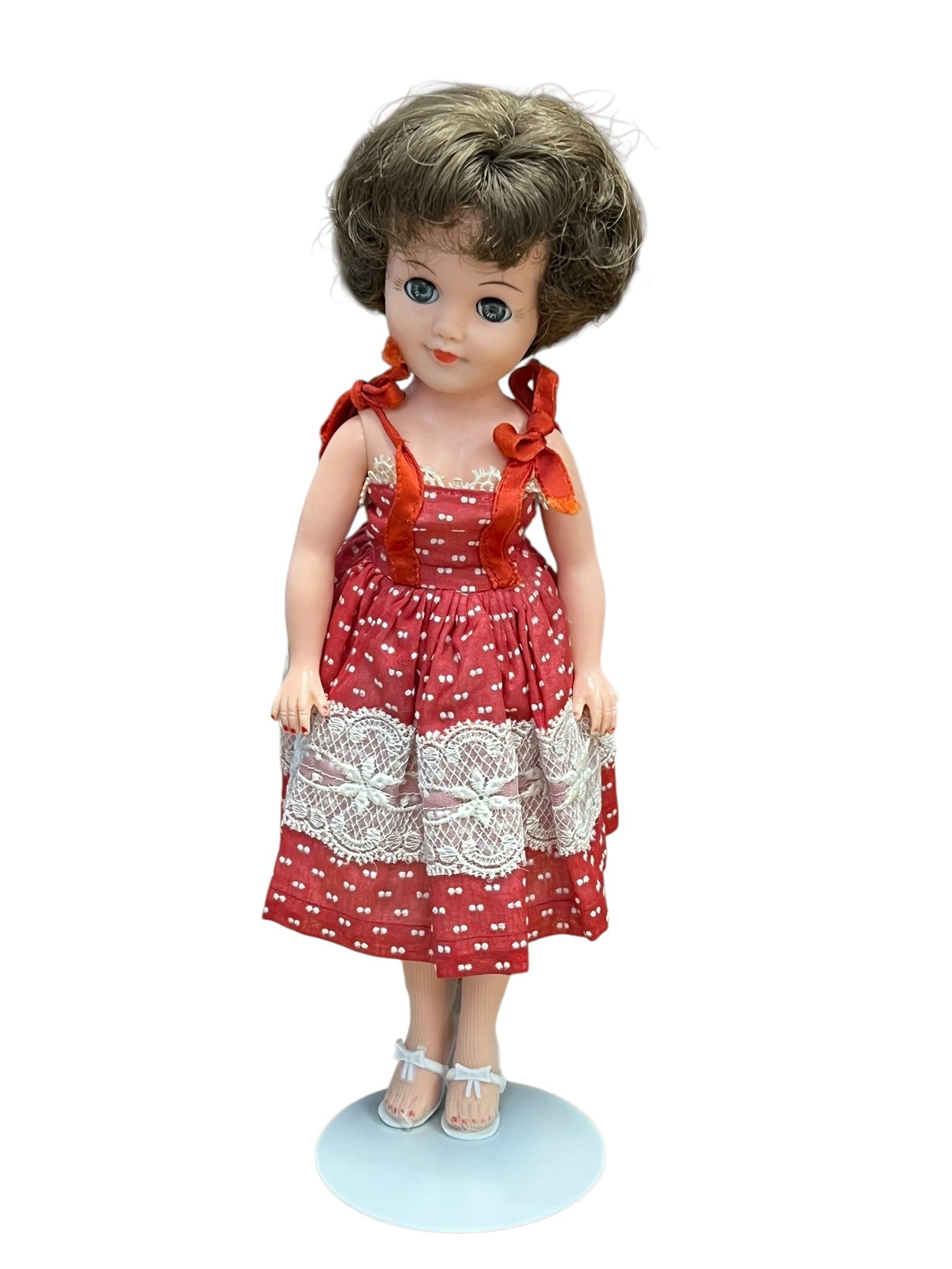 Vogue Vinyl Doll: This is a vintage vinyl mid-century fashion doll, closely resembling classic 1950s styles such as the Ideal Miss Revlon or the American Character Toni Doll.Key CharacteristicsFeatures: It features a