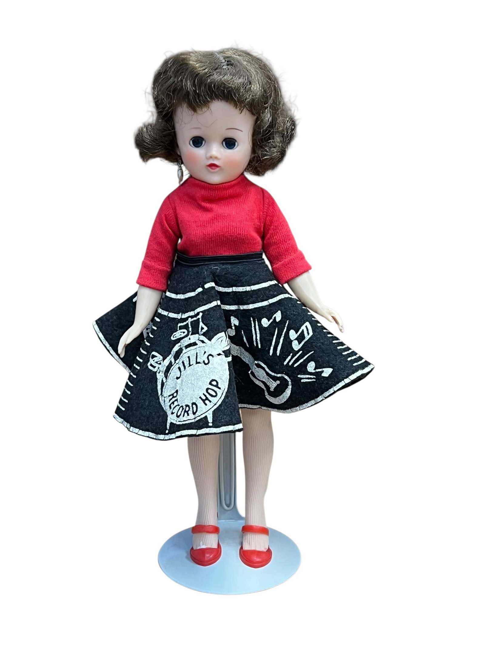 Vogue “Jill?? Plastic Doll: vintage Vogue Jill doll from 1957 wearing the original "Record Hop" felt skirt and red sweater outfit. [1, 2]Doll details: Produced by Vogue Dolls, Inc. as the older teenage sister to the popular Ginn