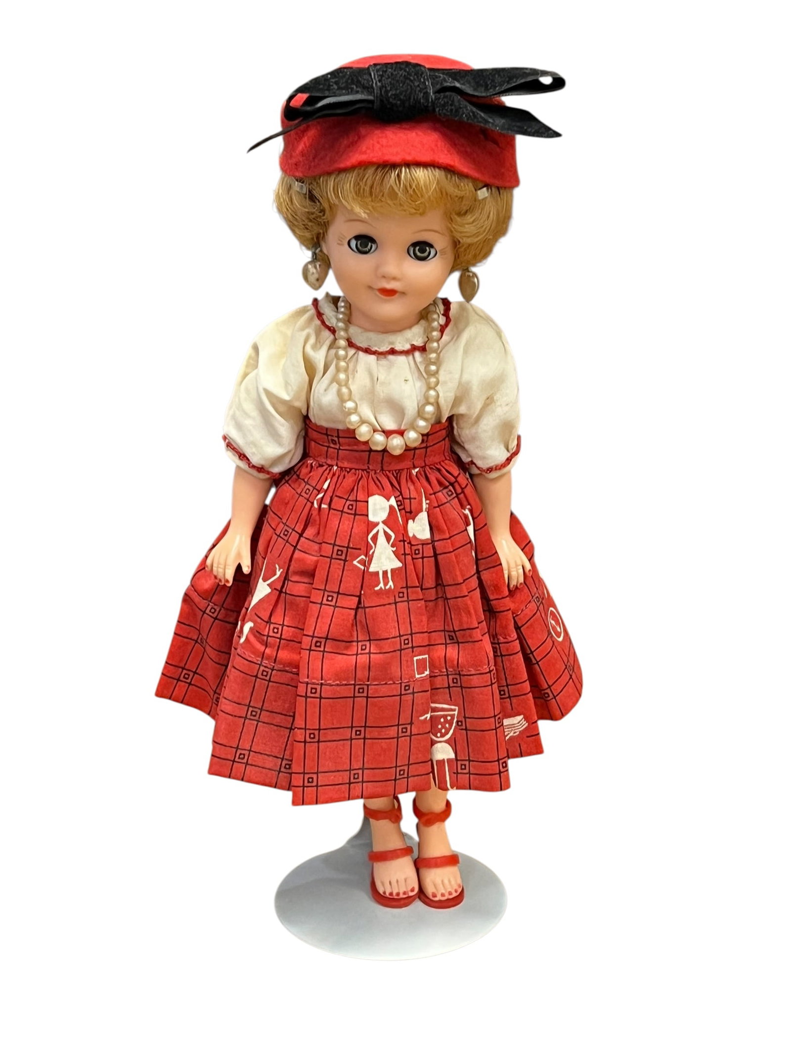 Vogue Vinyl Doll: This collectible figurine is a vintage 1950s Madame Alexander Cissette doll. Introduced by the Madame Alexander Doll Company in 1957, Cissette was designed as a sophisticated 10-inch fashion doll