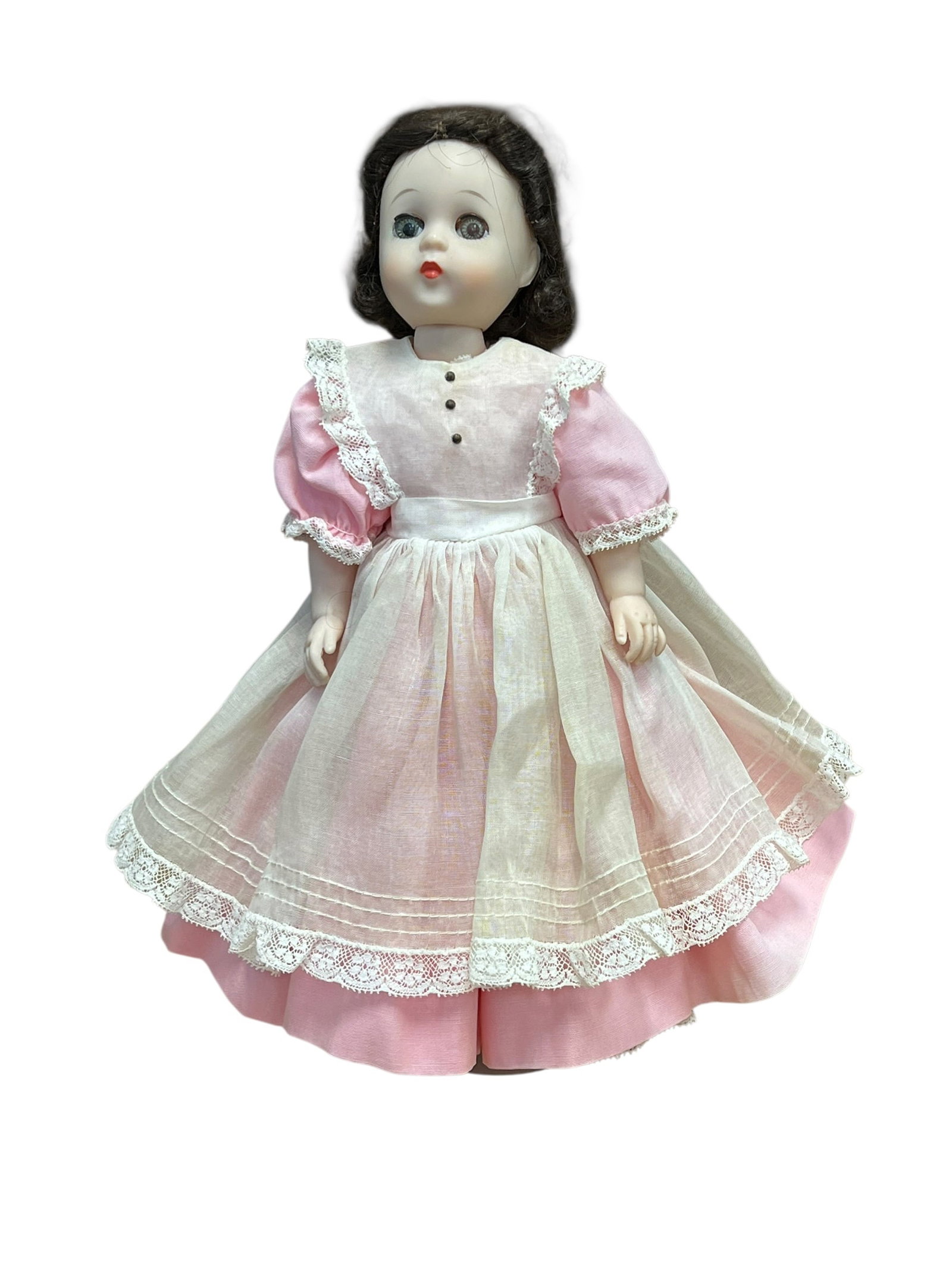 Madame Alexander “Beth?? Doll: This appears to be a vintage Madame Alexander "Beth" doll from the Little Women series, featuring short dark hair and a pink-and-white dress with lace trim. [1, 2]Doll OverviewCharacter: Beth from