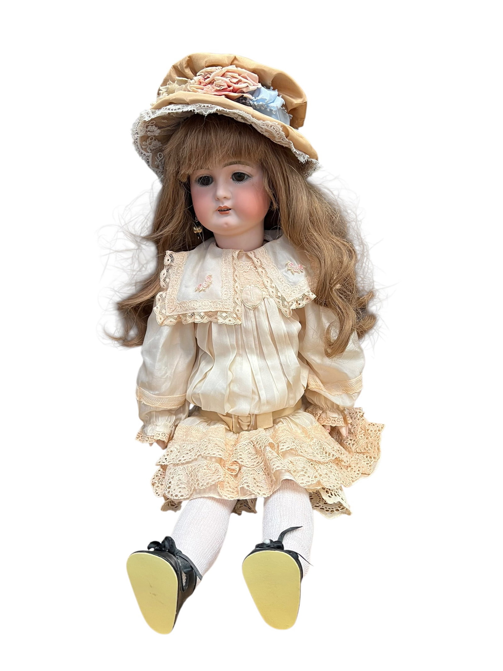 7913 Doll: antique or vintage bisque porcelain doll dressed in a cream-colored lace dress and a matching bonnet with pink floral details. [1, 2]It features a bisque porcelain head with painted facial features