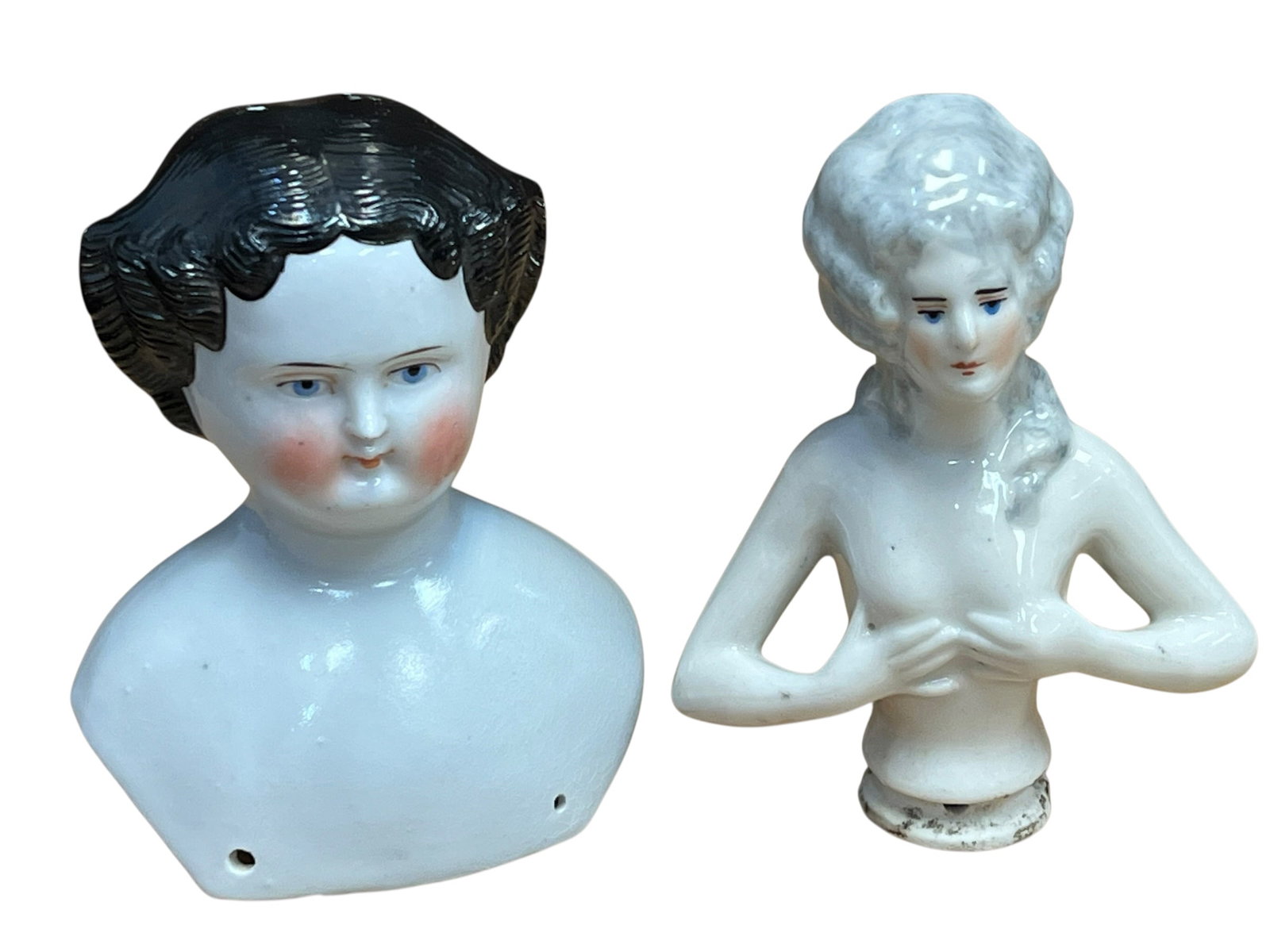 Lot of 2 China Doll Heads: two antique German porcelain doll components, highlighting different historical styles and uses: [1, 2]Left (Antique China Shoulder Head): This is a classic mid-to-late 19th-century German china doll 