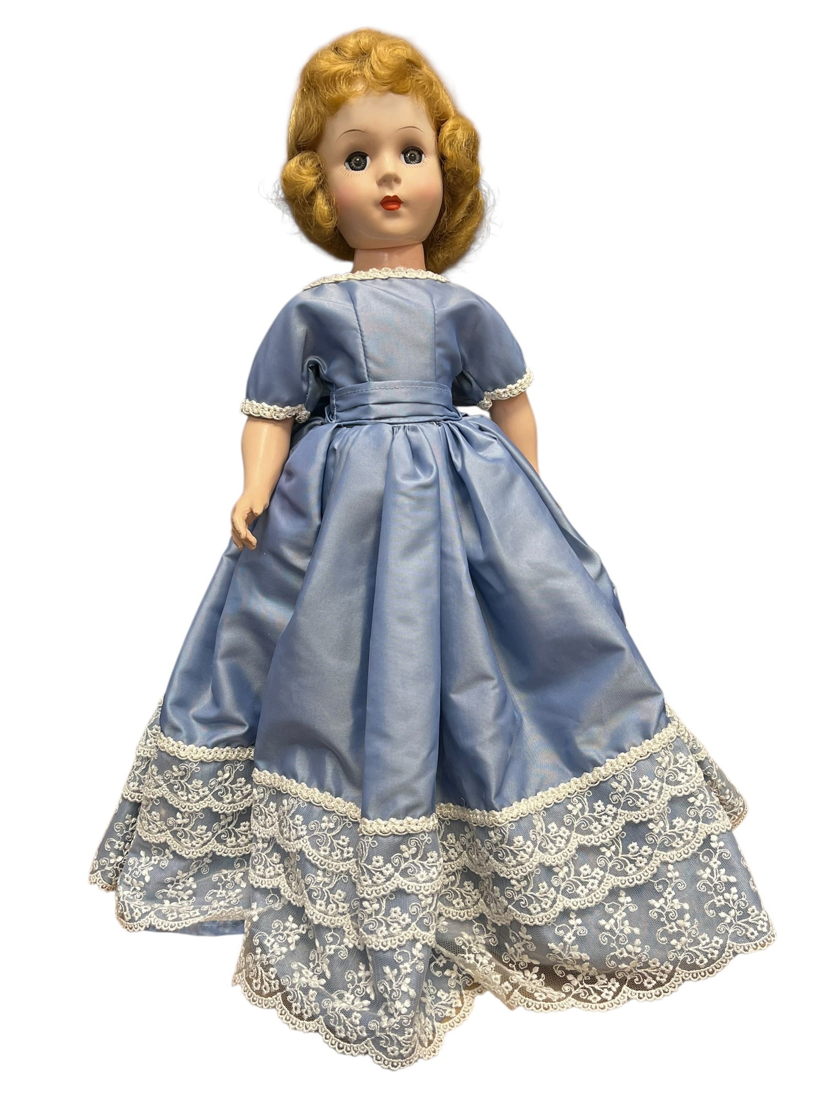 Composition Doll: vintage mid-20th-century hard plastic walker doll, such as an American Character Sweet Sue or a similar fashion/walker doll from the 1950s, dressed in a light blue gown with white lace trim