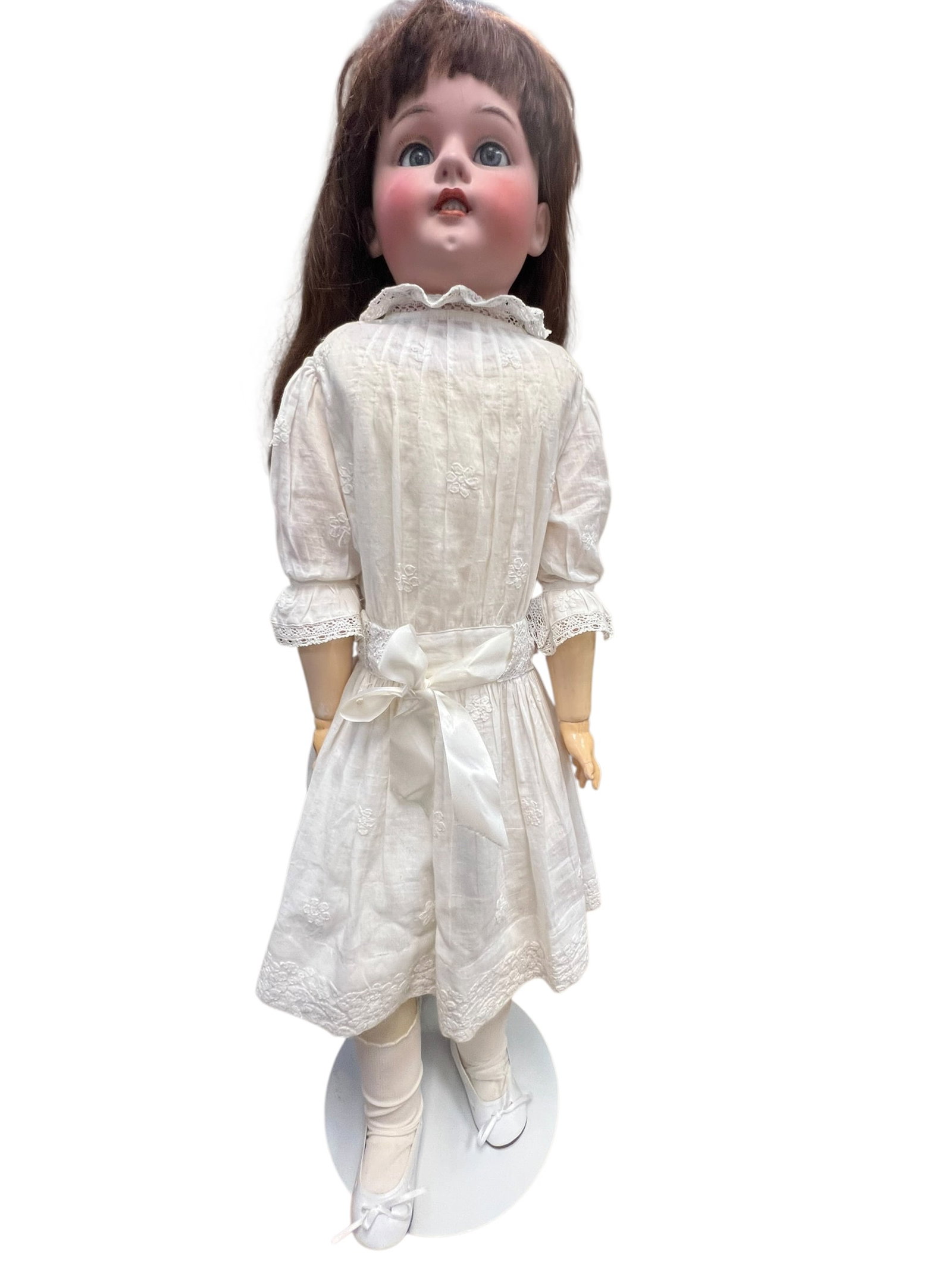 S&H Germany Bisque Head Doll: antique bisque-head doll, resembling a vintage German or Japanese socket-head doll from the late 19th or early 20th century, dressed in a white embroidered dress with a matching waist bow.