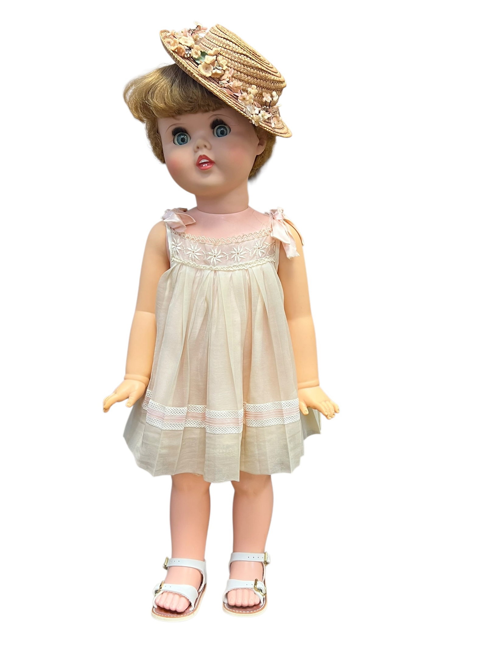 Vinyal Doll: vintage 1960 American Character "Toodles" doll featuring signature "peek-a-boo" follow-me eyes and a classic party dress. [1, 2]Key FeaturesMaker: Produced by the American Character Doll