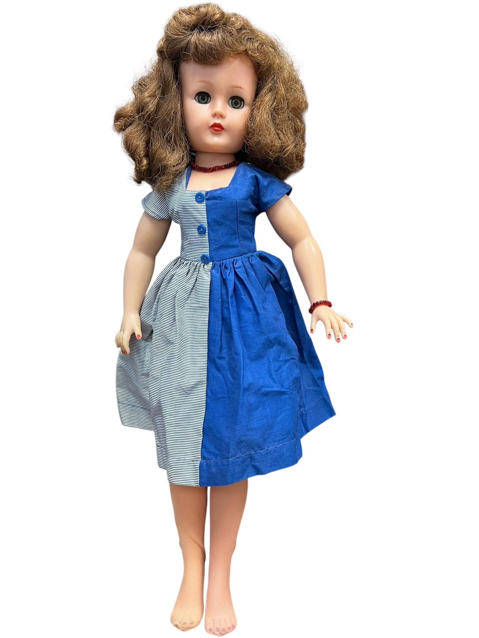 Ideal Vinyl Doll: This is a vintage 1950s Ideal Miss Revlon doll, likely a 22-inch model (VT-22) or a similar size class, featuring distinct sleep eyes, a twist waist, and mid-century styling. [1, 2]While the doll