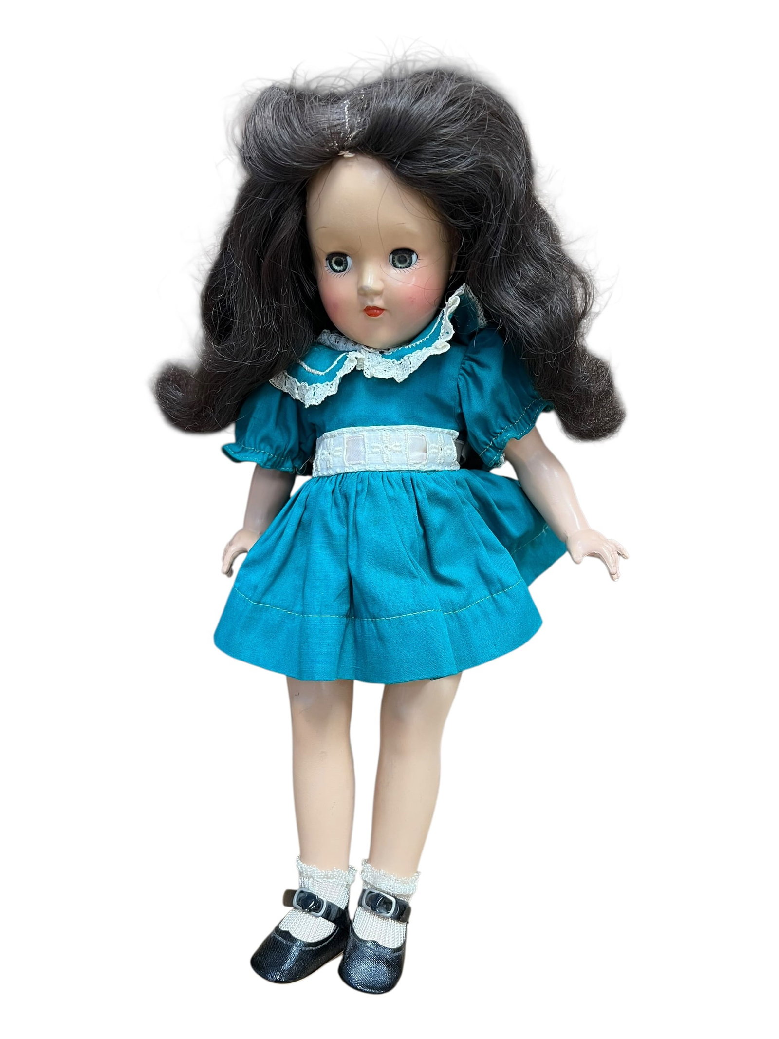 Ideal Genuine Toni Doll: This item appears to be a vintage 14-inch Ideal Toni Doll produced in the early 1950s. [1, 2]Doll DetailsMaker: Manufactured by the Ideal Toy Company.Time Period: Released around 1949 to 1953,