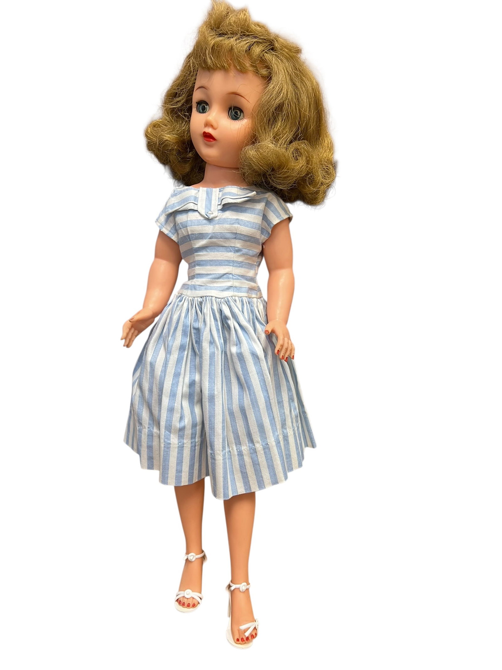 Ideal VT-20 Vinyl Doll: This appears to be a vintage 1950s Ideal Miss Revlon fashion doll wearing a classic blue-and-white striped dress. [1, 2, 3]Key DetailsMaker: Ideal Toy CorporationEra: Late 1950s, a popular pre-Barbie