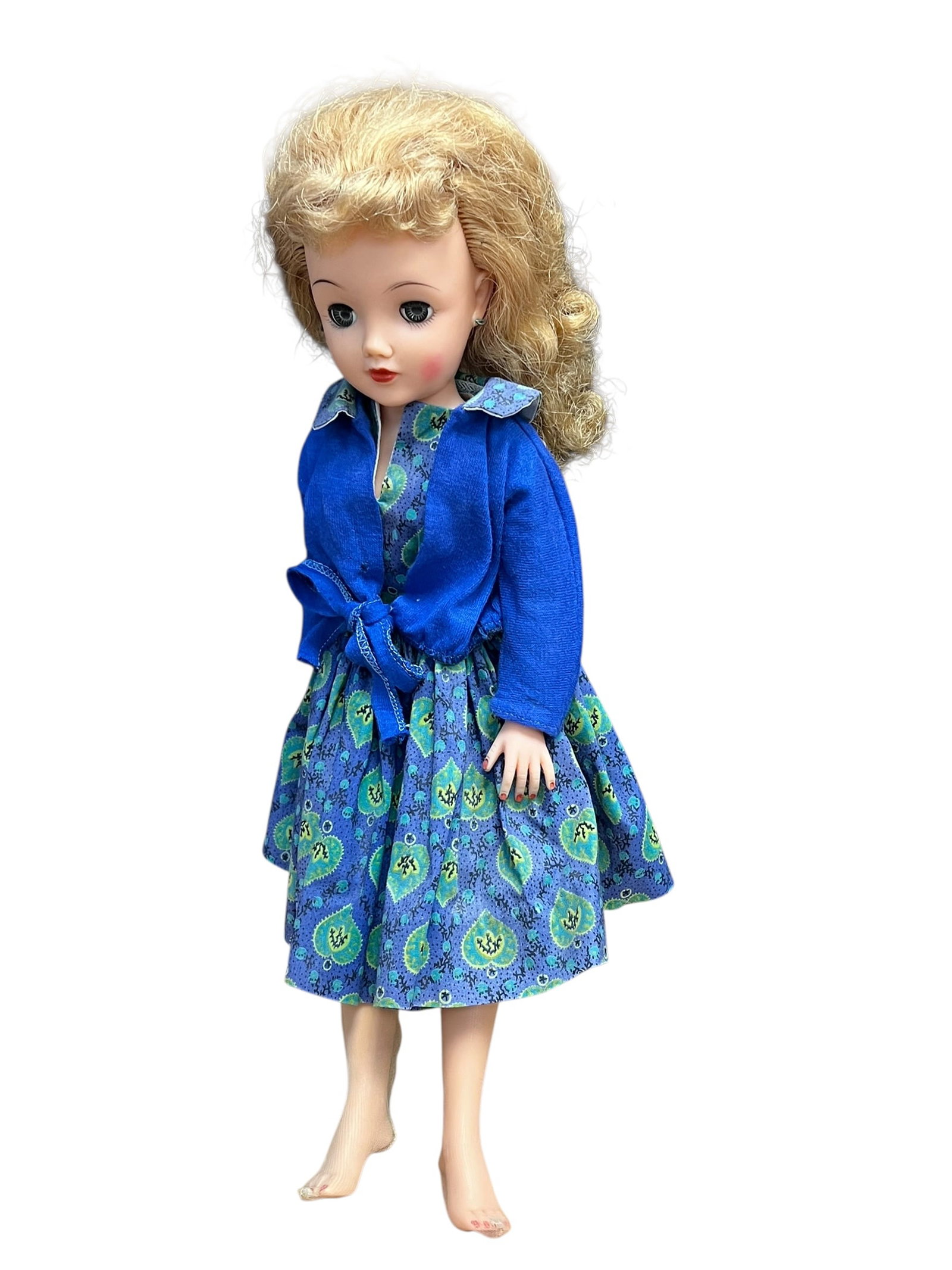 Ideal VT-18 Vinyl Doll: vintage 1950s fashion doll, resembling a Little Miss Revlon Doll by Ideal Toy Corporation, styled with rooted blonde curly hair and wearing a blue patterned dress with a matching blue tie-front jacket