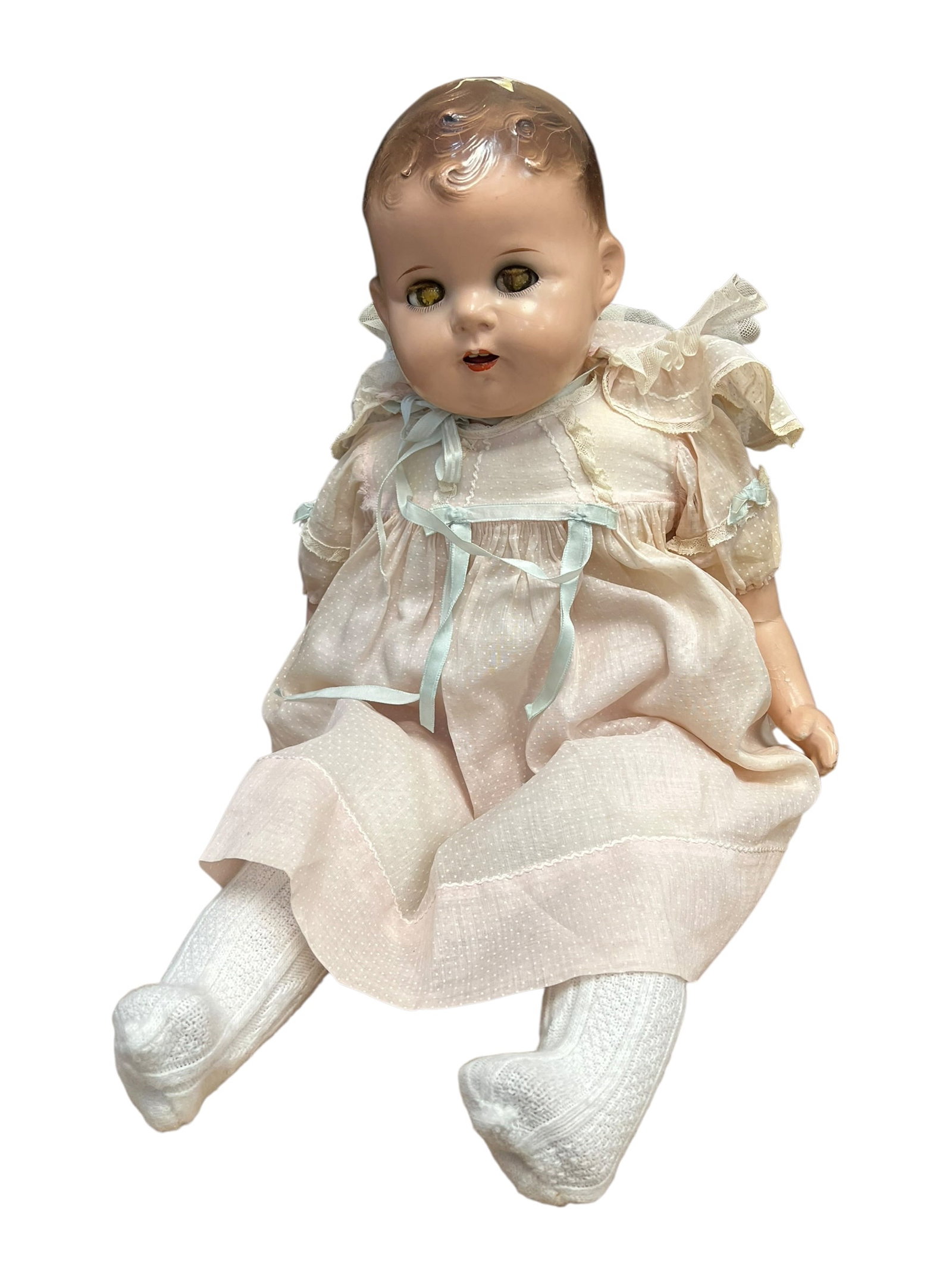 Composition Doll: This appears to be a vintage composition baby doll from the 1930s or 1940s featuring a cloth body, molded painted hair, and sleep eyes. [1, 2, 3]Key Visual DetailsMaterials: The head and limbs appear 