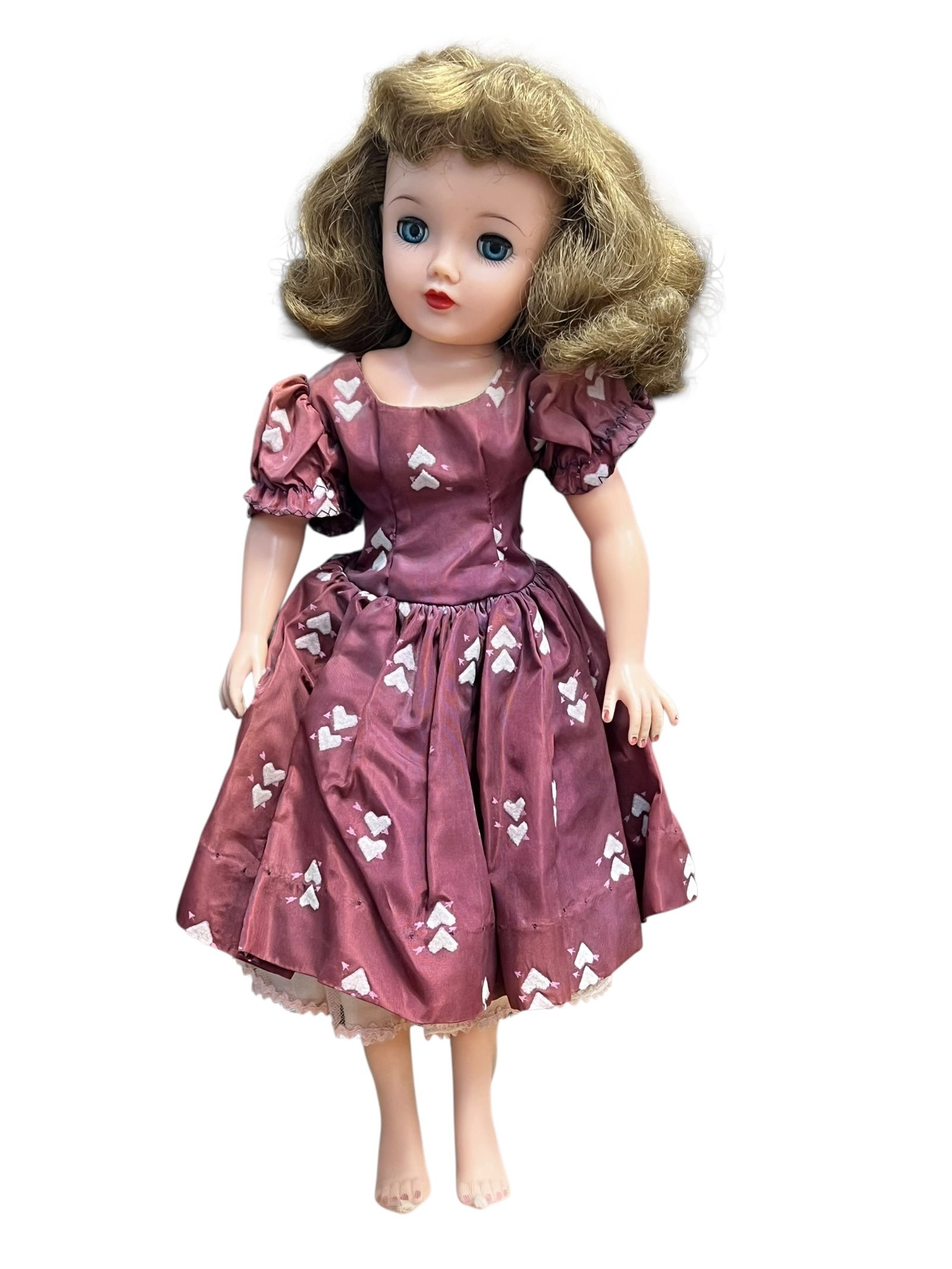 Ideal VT-18 Vinyl Doll: This appears to be a vintage 1950s Ideal Miss Revlon fashion doll wearing a plum-colored dress with a white heart pattern. [1, 2]Key FeaturesMaker: Ideal Toy Corporation, popular during the late