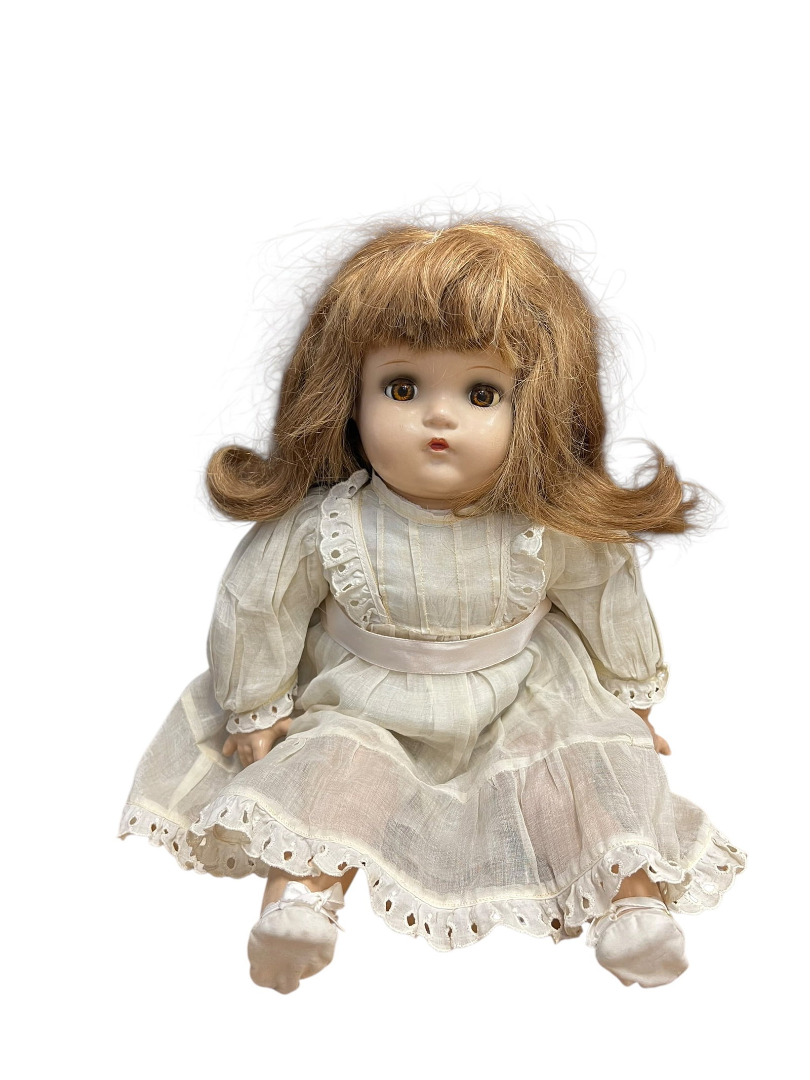 Madame Alexander Doll: This is an antique or vintage toddler doll, most likely dating between the 1920s and 1940s.Based on its facial structure, chubby cheeks, pouty lips, and style of side-flipped hair, it closely