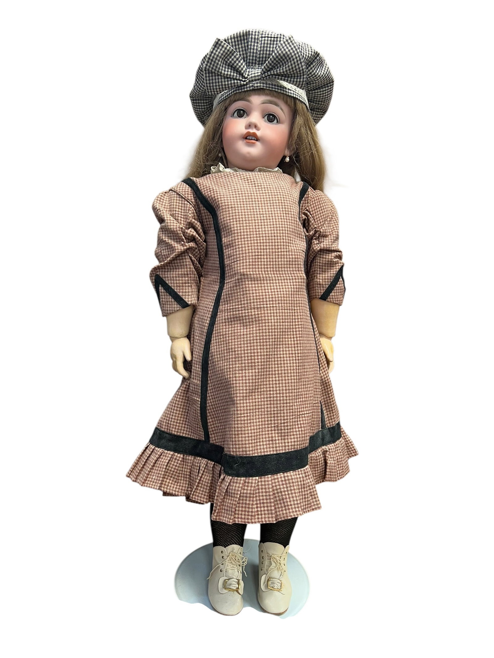 DEP Bisque Head Doll: antique bisque-head doll dressed in a vintage gingham dress and matching patterned bonnet. [1]Key FeaturesHead: Made of tinted or pale bisque porcelain with delicate painted features, inset eyes, and 