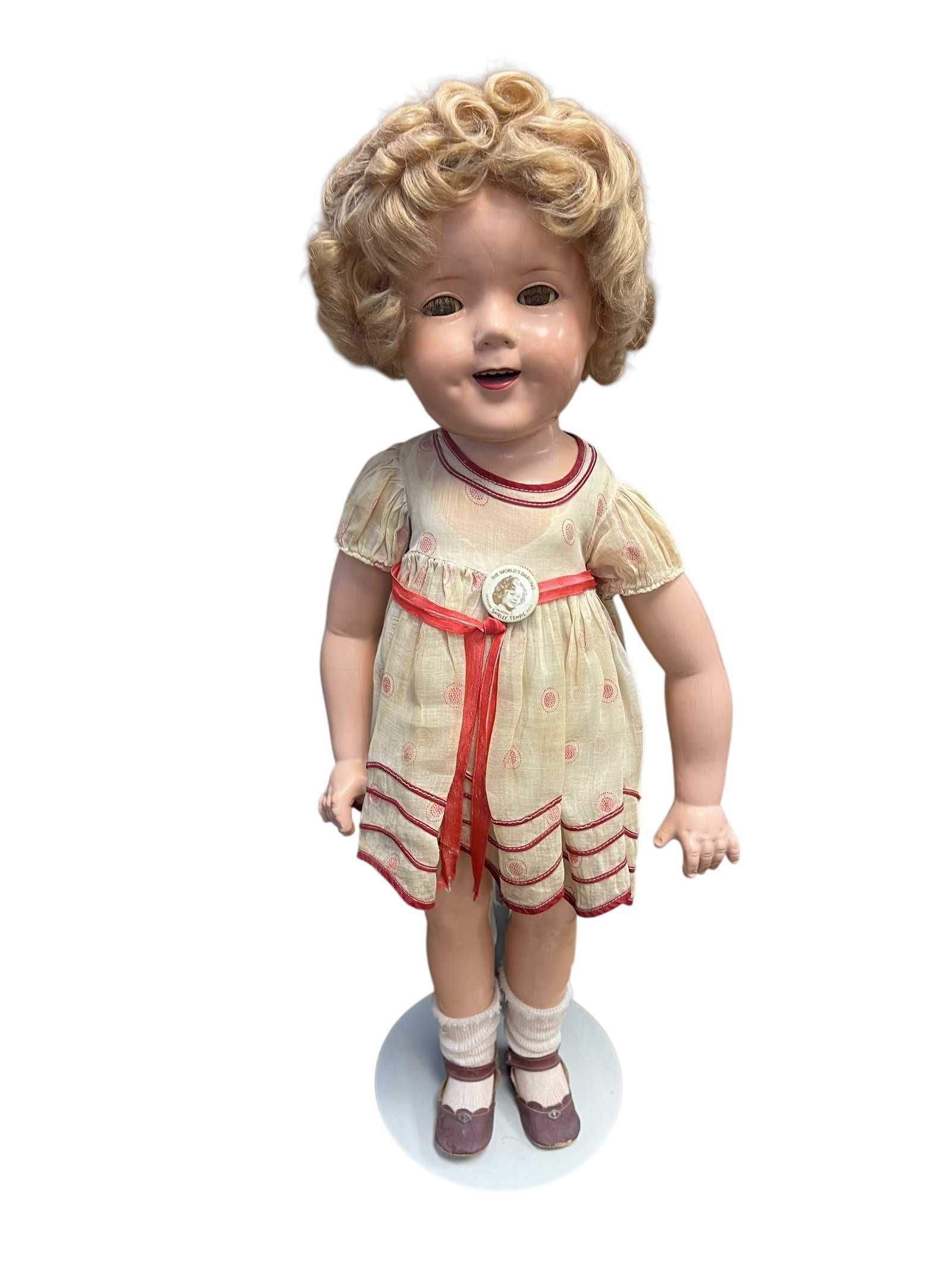 Shirley Temple Doll: vintage 1930s Shirley Temple composition doll made by the Ideal Novelty & Toy Co. [1]Key FeaturesMaterial: Crafted from composition (a molded mix of wood pulp, glue, and other materials).Hair and