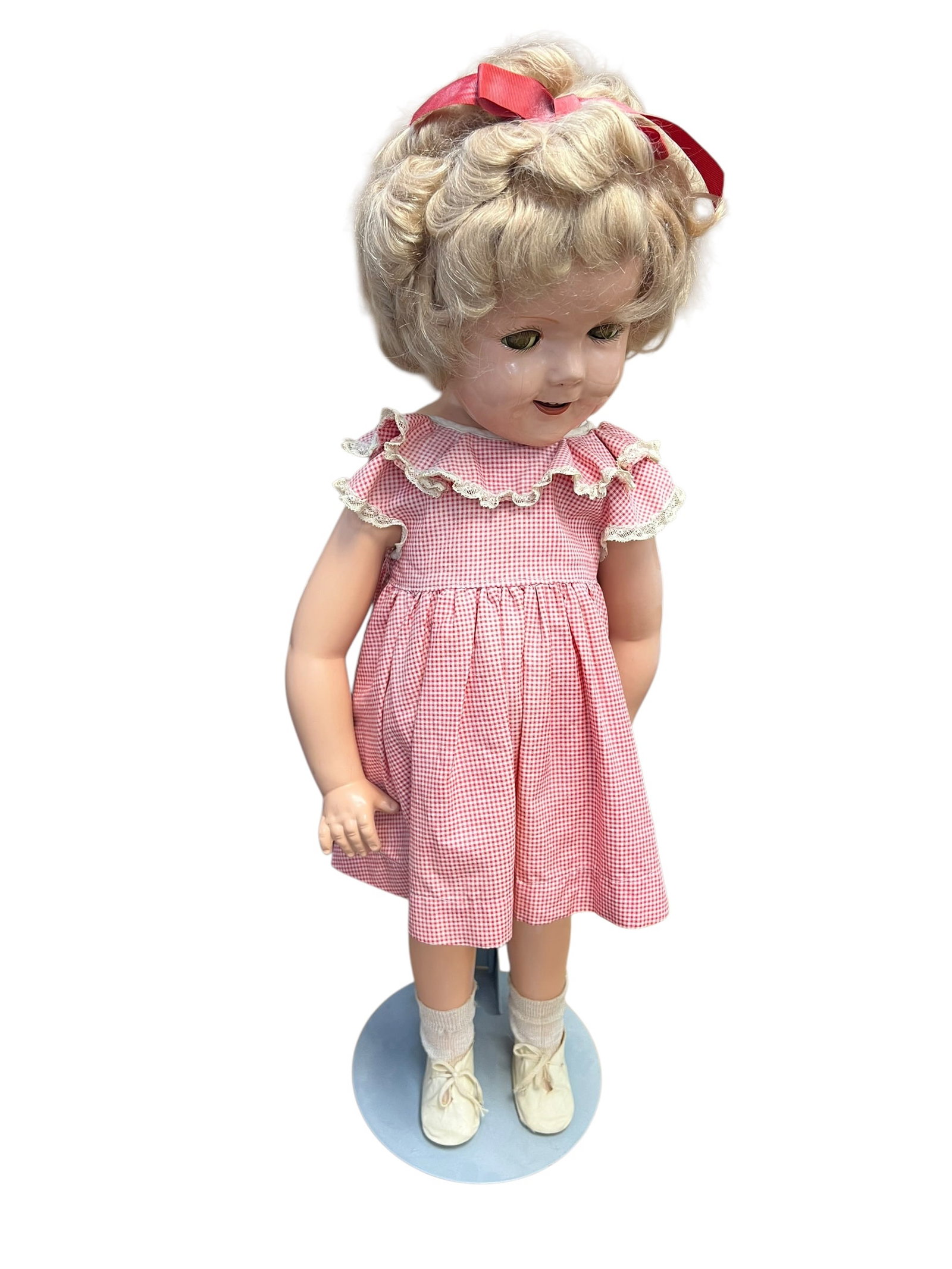 Shirley Temple Doll: vintage composition doll, closely resembling a 1930s Shirley Temple doll by Ideal Toy Company, wearing a red and white checkered dress. [1, 2, 3, 4, 5, 6, 7, 8]Features a short blonde wig with ringlet