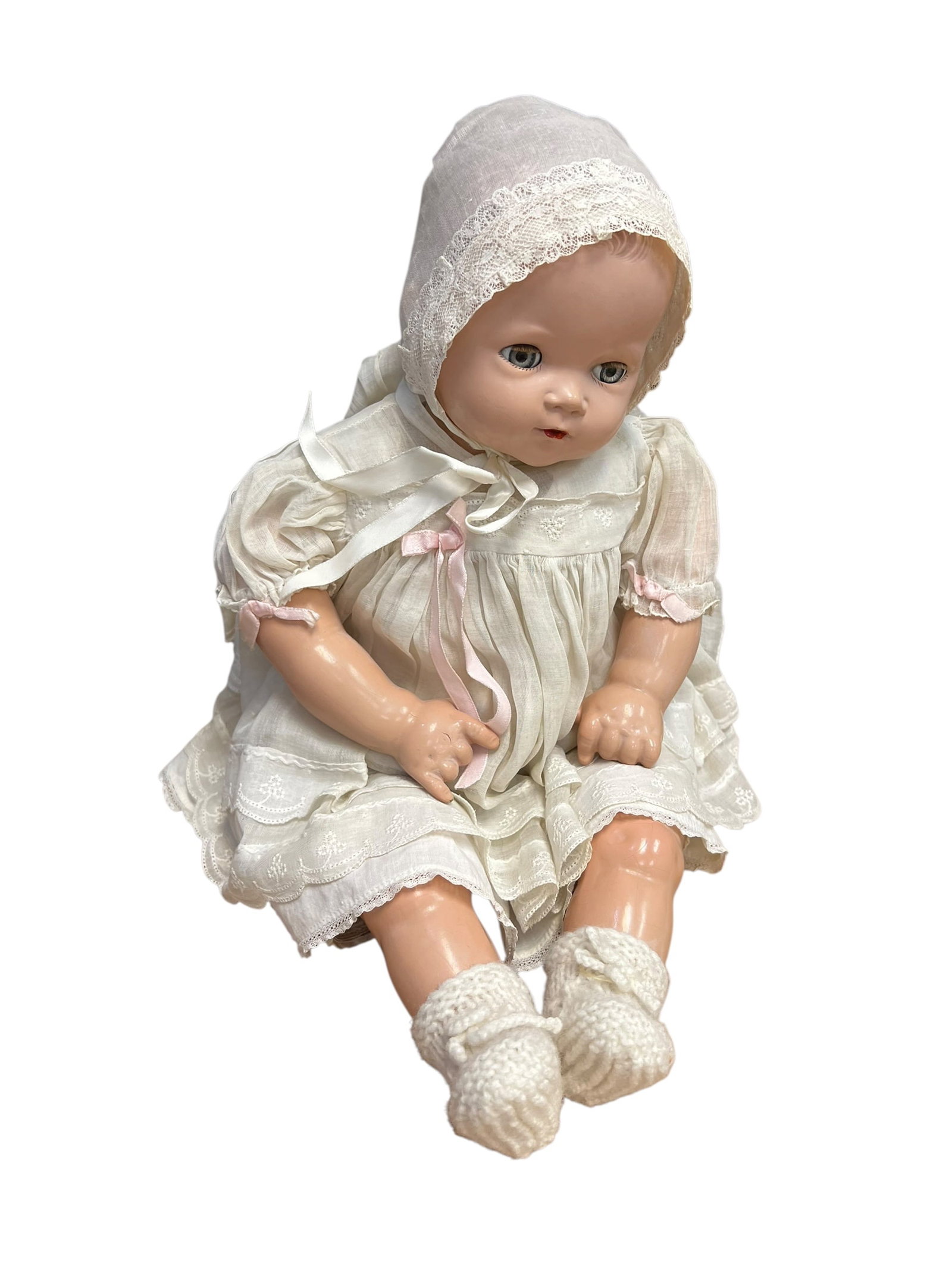 1946 Ideal Doll: vintage composition baby doll, likely from the early-to-mid 20th century. [1, 2]Features: It has painted facial features, blue eyes, molded hair, and glossy composition limbs.Clothing: The doll is