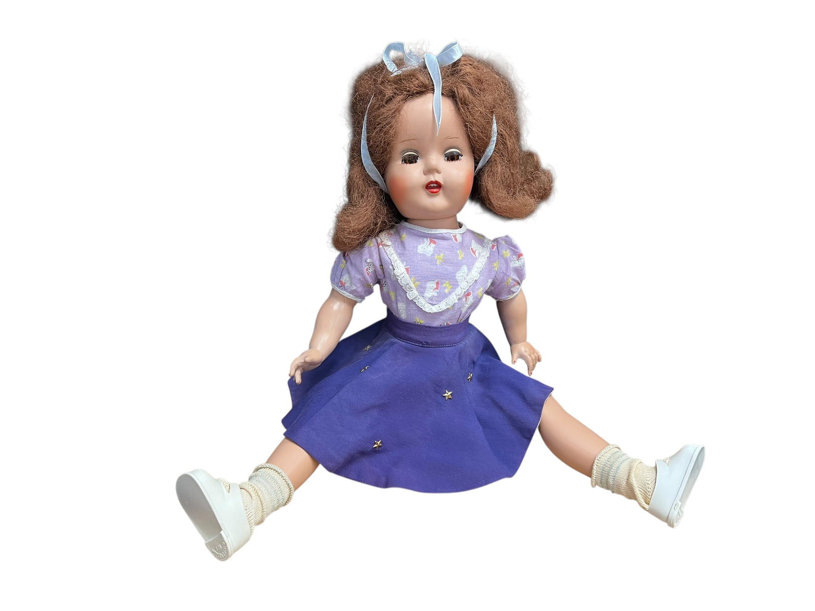 Composition Doll: antique German china head doll, recognizable by its characteristic glazed porcelain (china) shoulder head, molded blonde hair, and meticulously painted facial features.Dolls with this specific style