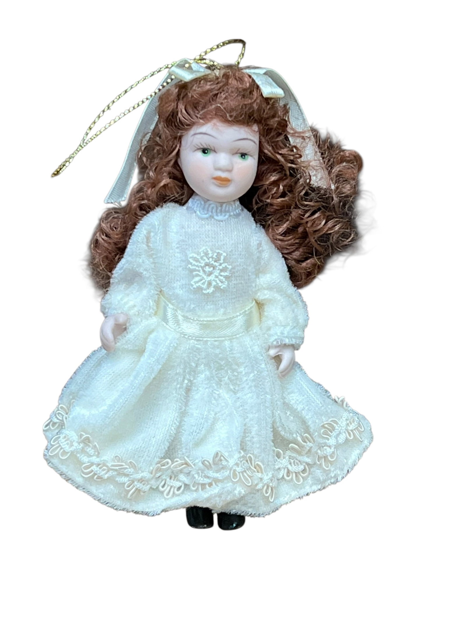 Bisque Head Doll Christmas Tree Ornament: miniature porcelain doll Christmas ornament. The doll features curly auburn or brown hair tied back with a white satin ribbon bow, painted facial features with blue or green eyes, and a full-length cr