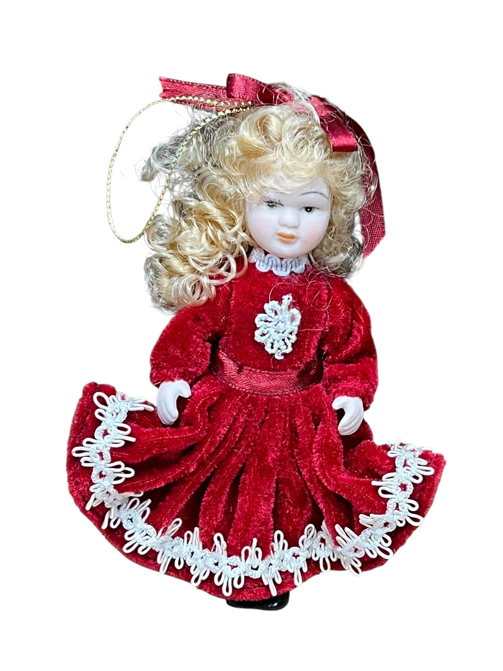 Bisque Head Doll Christmas Tree Ornament: miniature porcelain doll Christmas ornament. The doll features curly auburn or brown hair tied back with a white satin ribbon bow, painted facial features with blue or green eyes, and a full-length cr