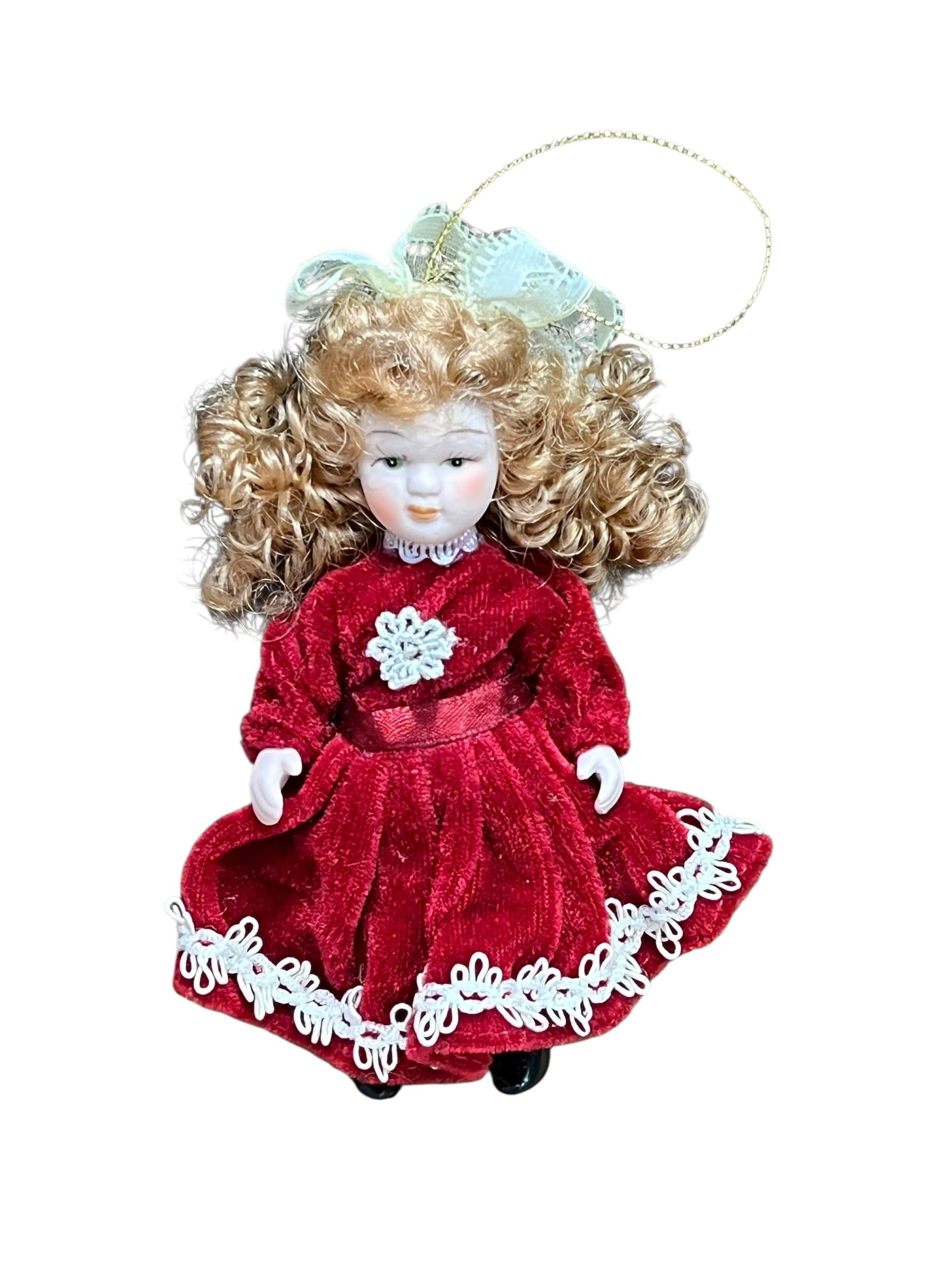 Bisque Head Doll Christmas Tree Ornament: miniature porcelain doll Christmas ornament. The doll features curly auburn or brown hair tied back with a white satin ribbon bow, painted facial features with blue or green eyes, and a full-length cr