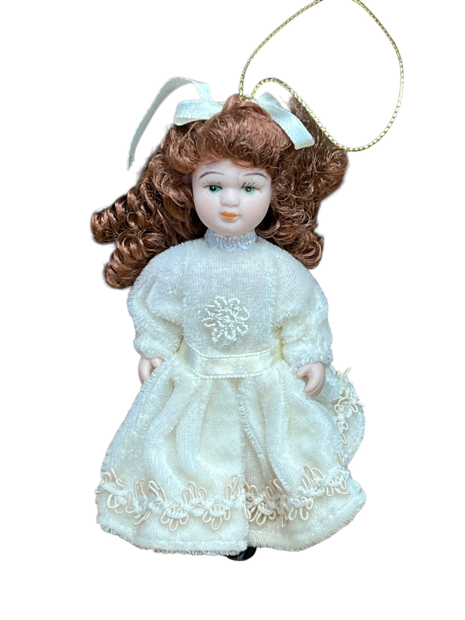 Bisque Head Doll Christmas Tree Ornament: miniature porcelain doll Christmas ornament. The doll features curly auburn or brown hair tied back with a white satin ribbon bow, painted facial features with blue or green eyes, and a full-length cr