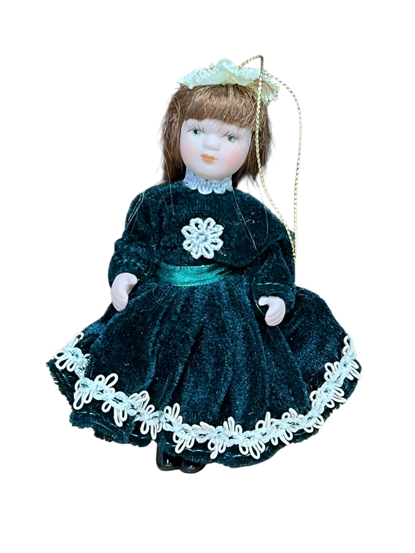 Bisque Head Doll Christmas Tree Ornament: miniature porcelain doll Christmas ornament. The doll features curly auburn or brown hair tied back with a white satin ribbon bow, painted facial features with blue or green eyes, and a full-length
