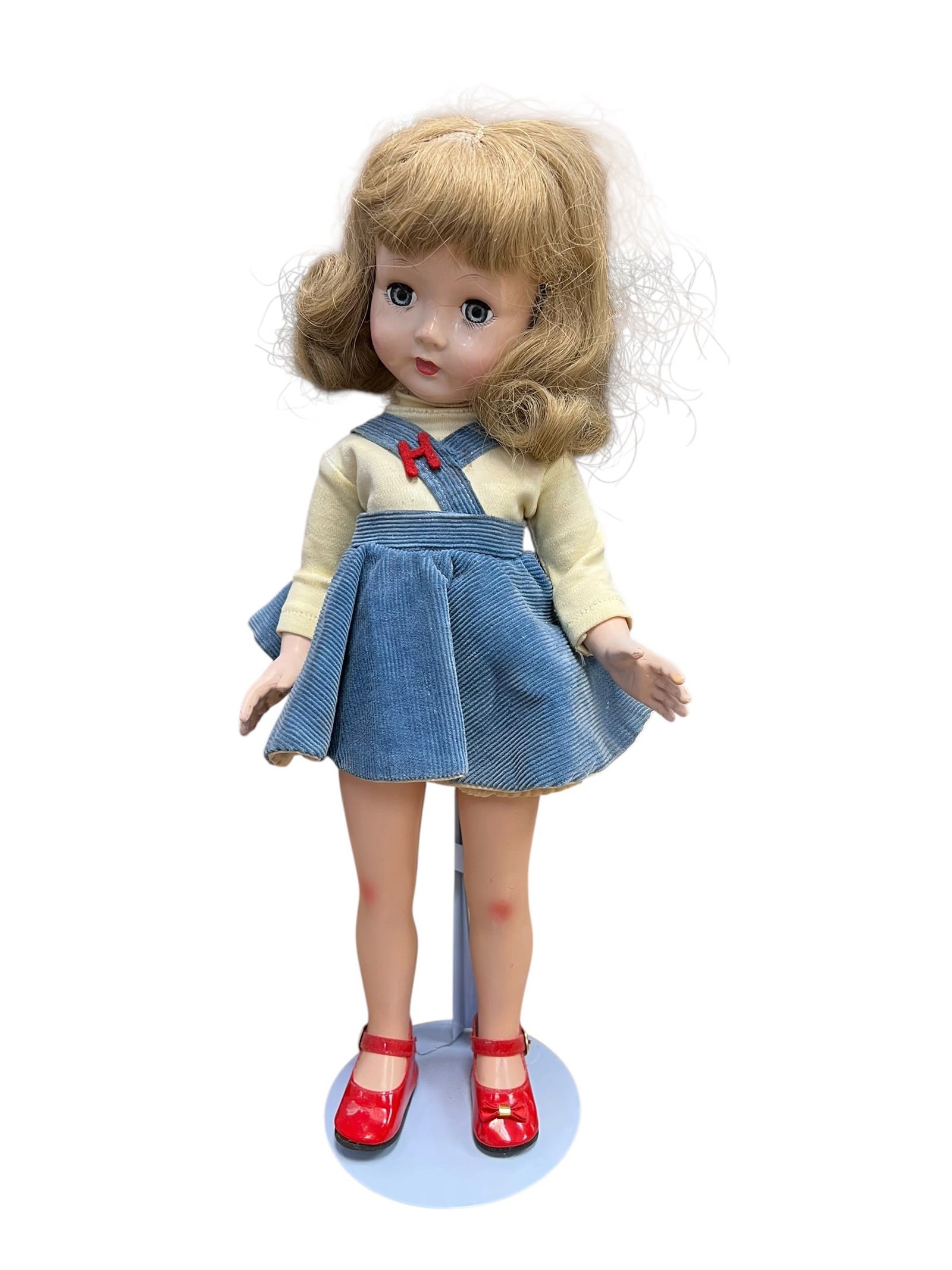 Effanbee Composition Doll: vintage hard plastic or vinyl doll from around the mid-20th century, styled similarly to classic models like the Ideal Toni Doll or Madame Alexander Maggie. She features blonde curly hair with bangs,
