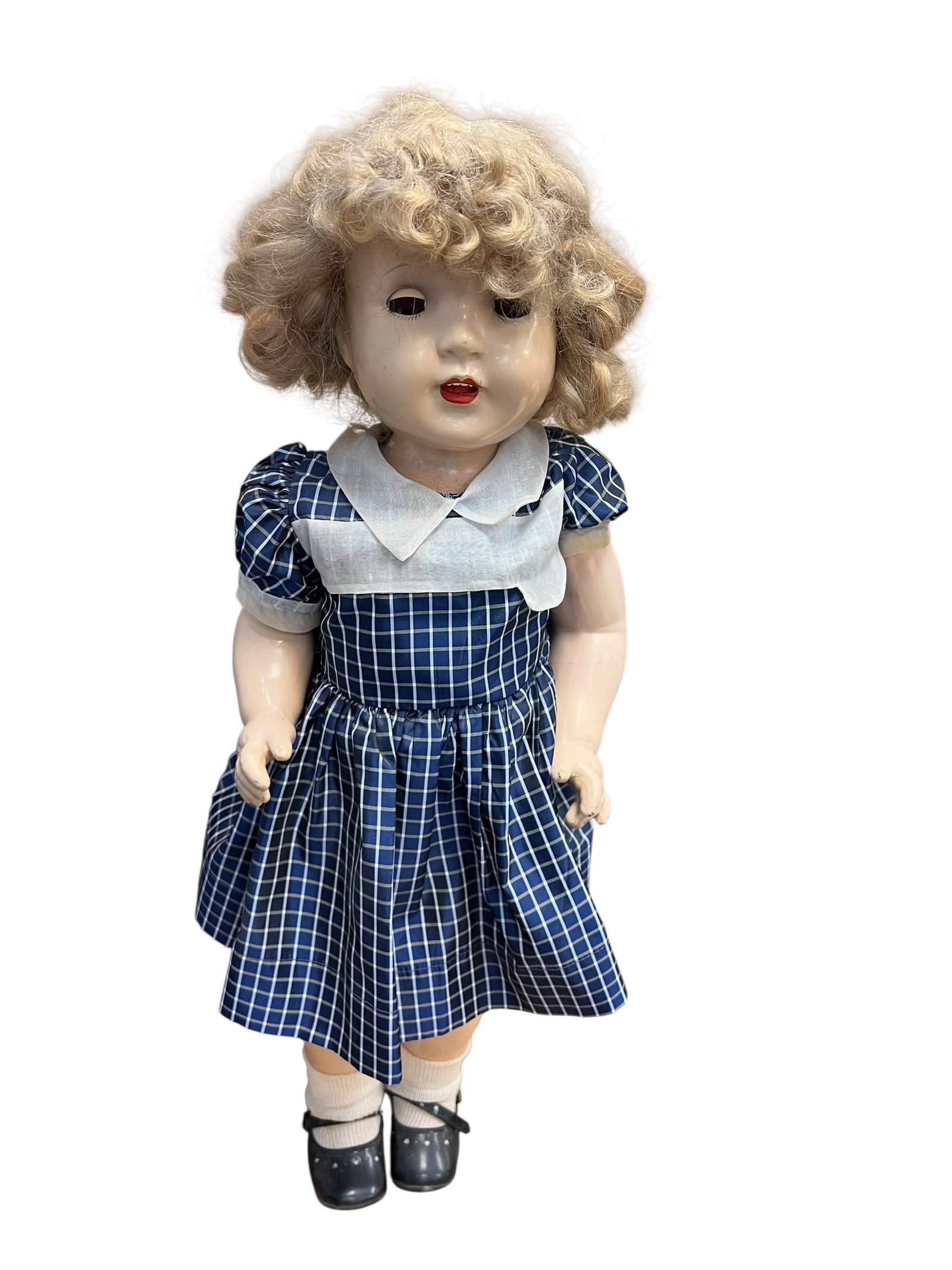 Composition Doll: vintage Shirley Temple composition doll, a highly collectible toy originally manufactured by the Ideal Novelty & Toy Company starting in the mid-1930s. [1, 2]Key Characteristics of this Doll:Material: