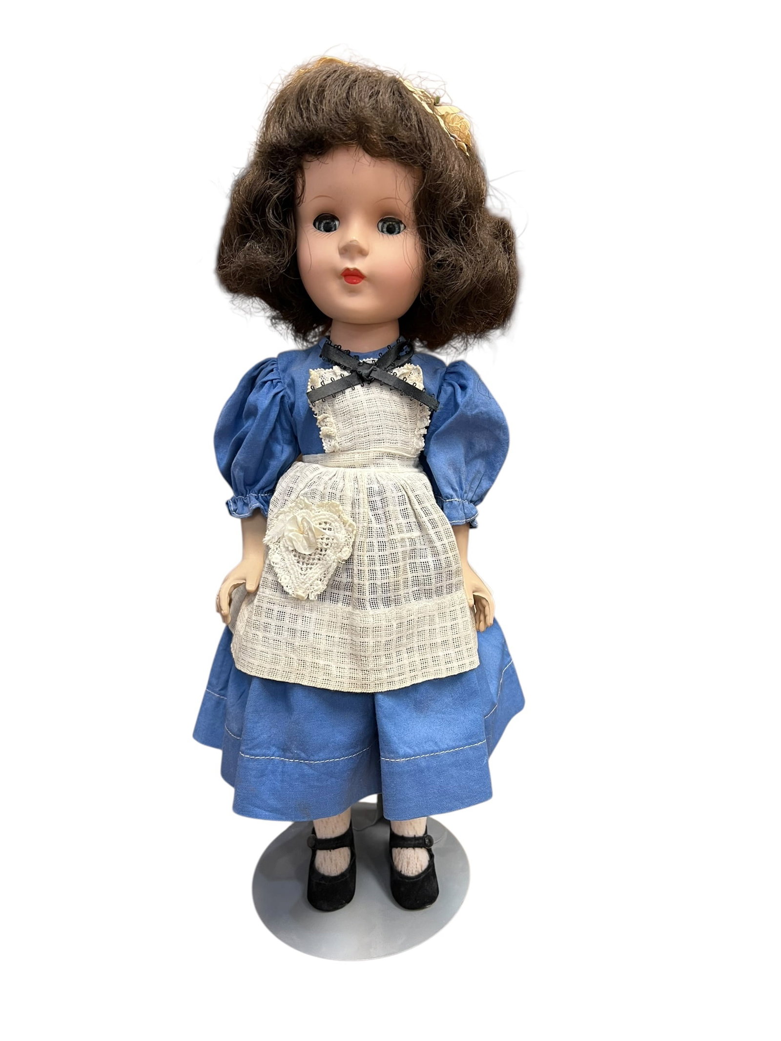 American Character Plastic Doll: This appears to be a vintage 1950s American Character Sweet Sue hard plastic doll dressed as Alice in Wonderland, featuring a blue dress, white lace apron, and brown hair.
