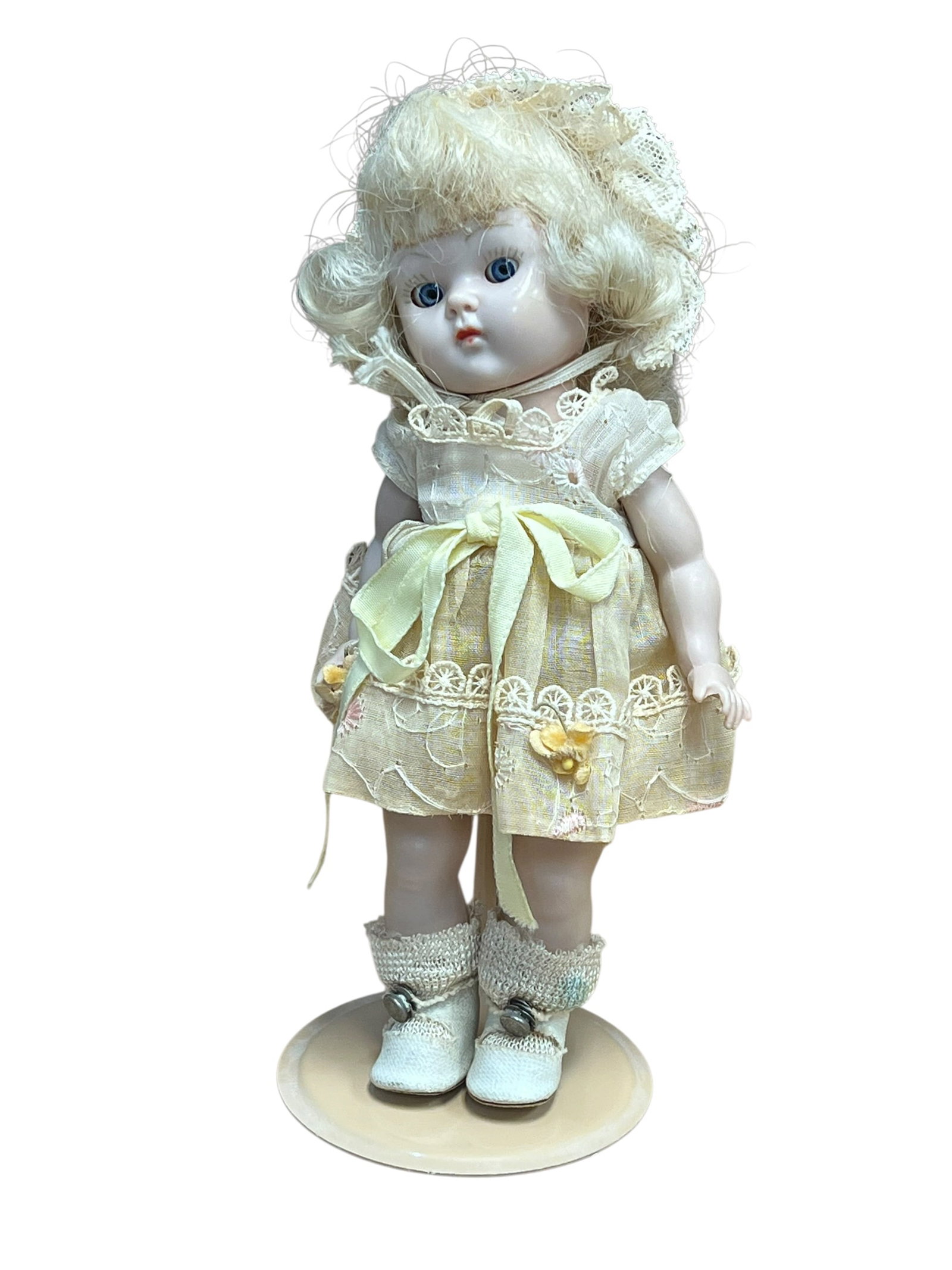Vogue Plastic Doll: Based on its distinct facial mold, side-glancing eyes, and pouting mouth, this is a vintage mid-century "Just Me" bisque porcelain doll. Originally designed by Armand Marseille in Germany during the