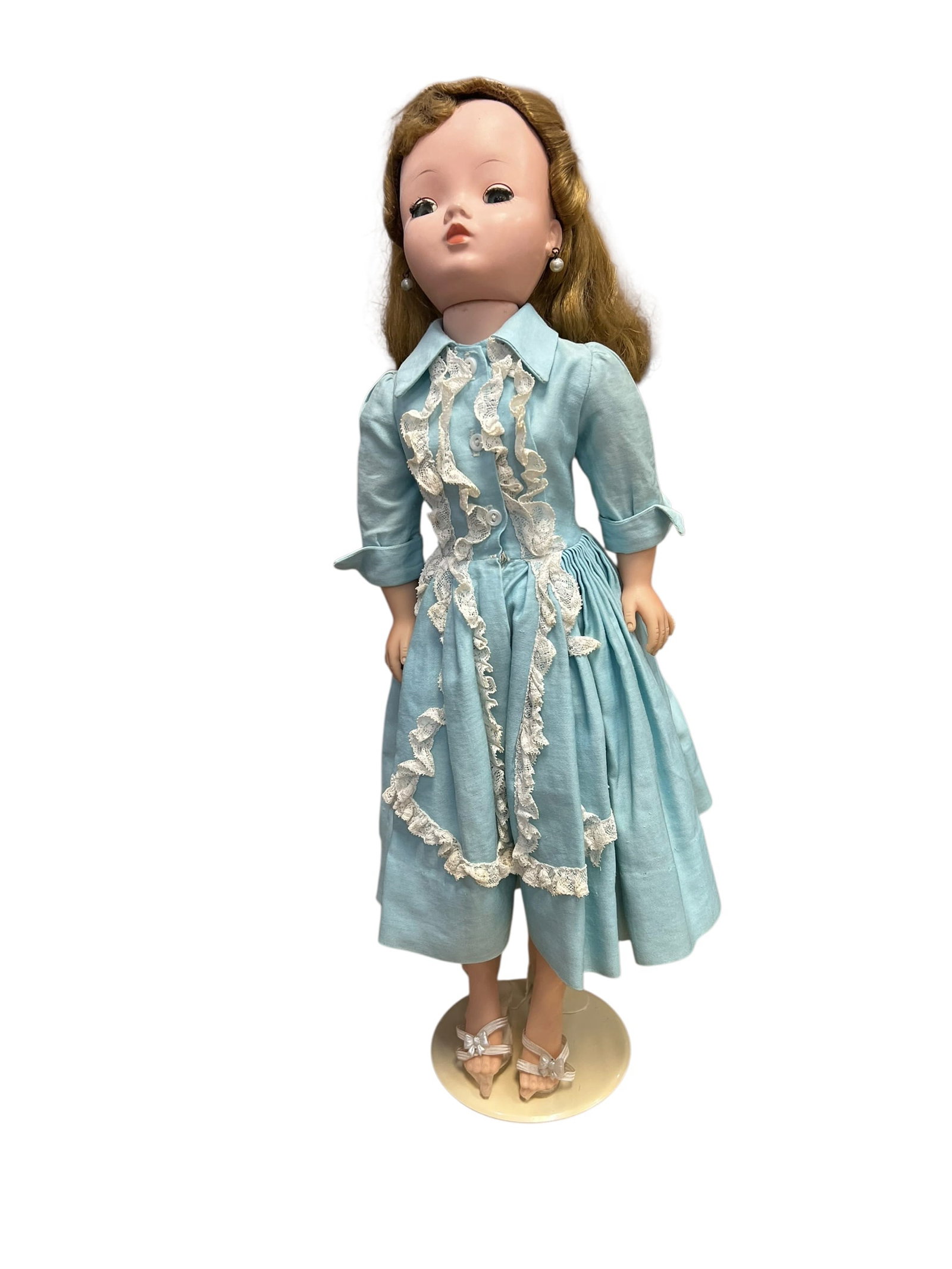 Madame Alexander Plastic Doll: This is a vintage 1950s Madame Alexander Cissy doll. [1, 2]She is pictured here wearing a classic 1957 aqua/light blue polished cotton dress featuring intricate "dressmaker touches" and elaborate