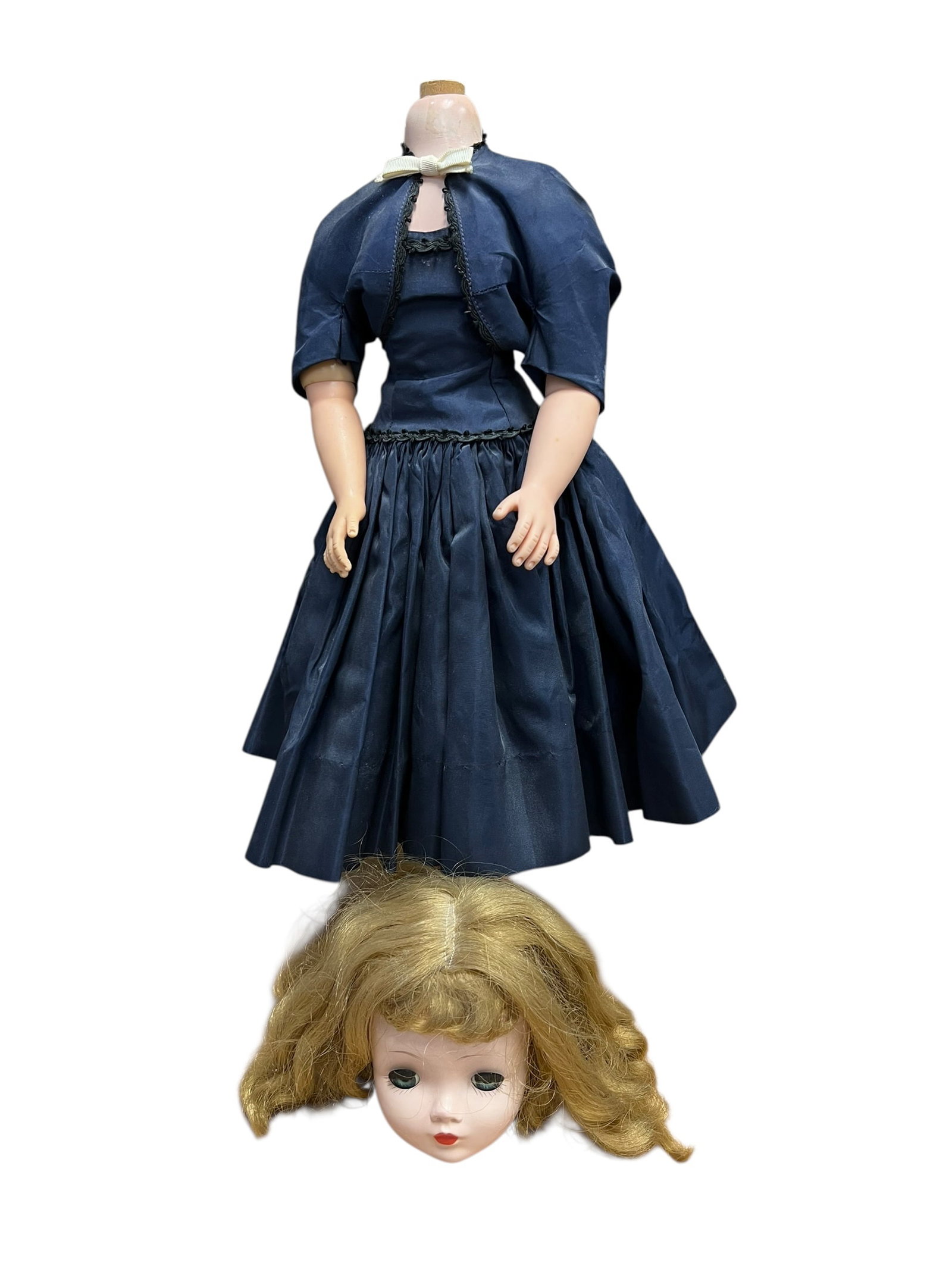 Madame Alexander Plastic Doll: this item appears to be a vintage Madame Alexander "Cissy" doll from the mid-1950s. [1]She is pictured here needing restrung or repaired, with her hard-plastic head separated from her jointed torso.