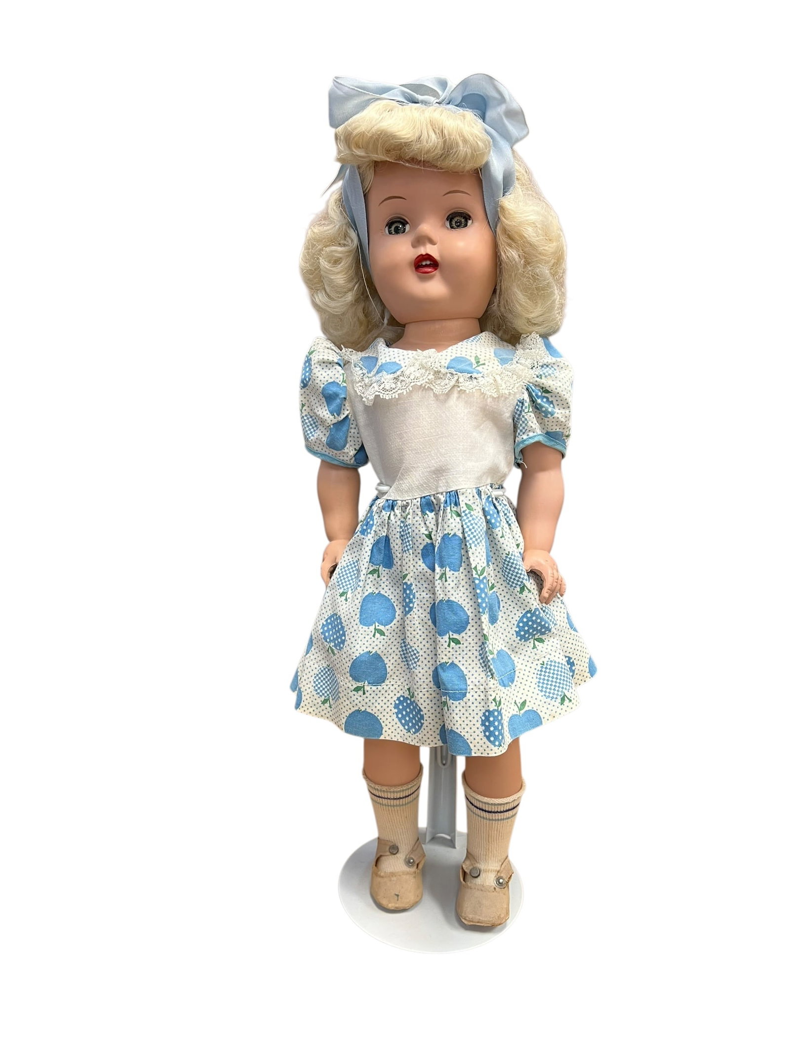 Ideal Toni Doll: This is a vintage Ideal Toni Doll from the early 1950s. Produced by the Ideal Toy Company, these classic dolls were famously made of hard plastic and tied to a marketing partnership with Gillette's