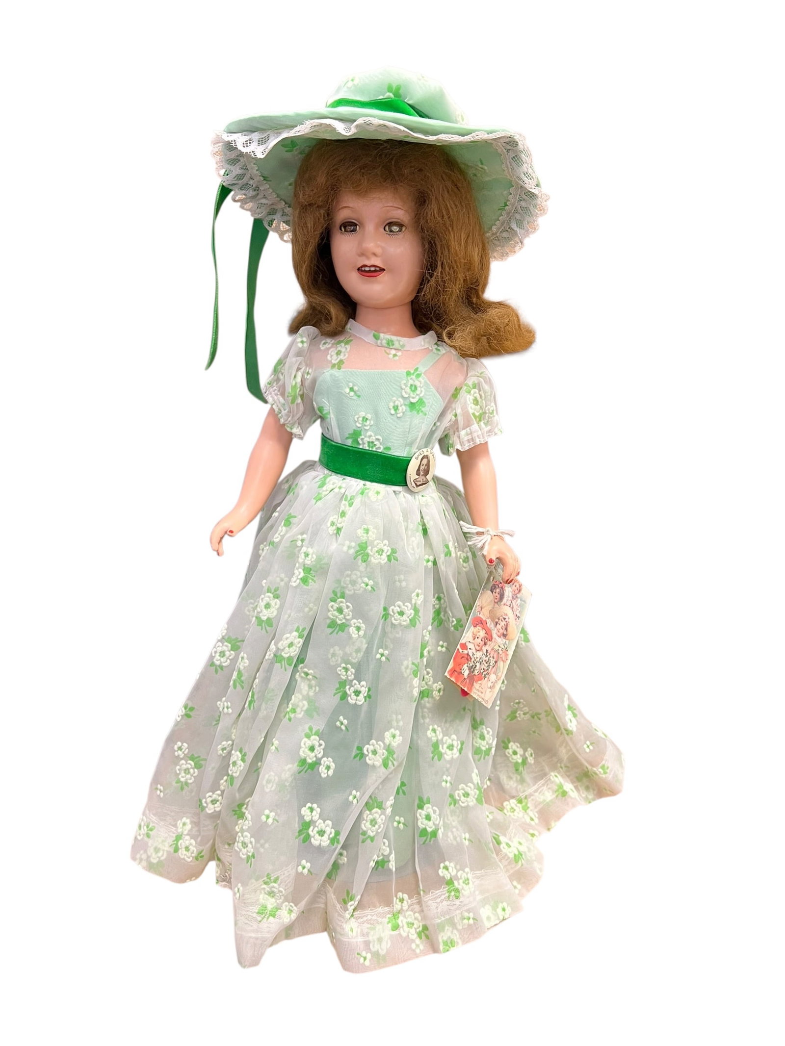 Ideal Composition Doll: vintage 21-inch Madame Alexander Scarlett O'Hara doll. Dressed in her iconic green floral picnic gown inspired by Gone with the Wind, she features a sheer floral overlay dress, a wide matching green