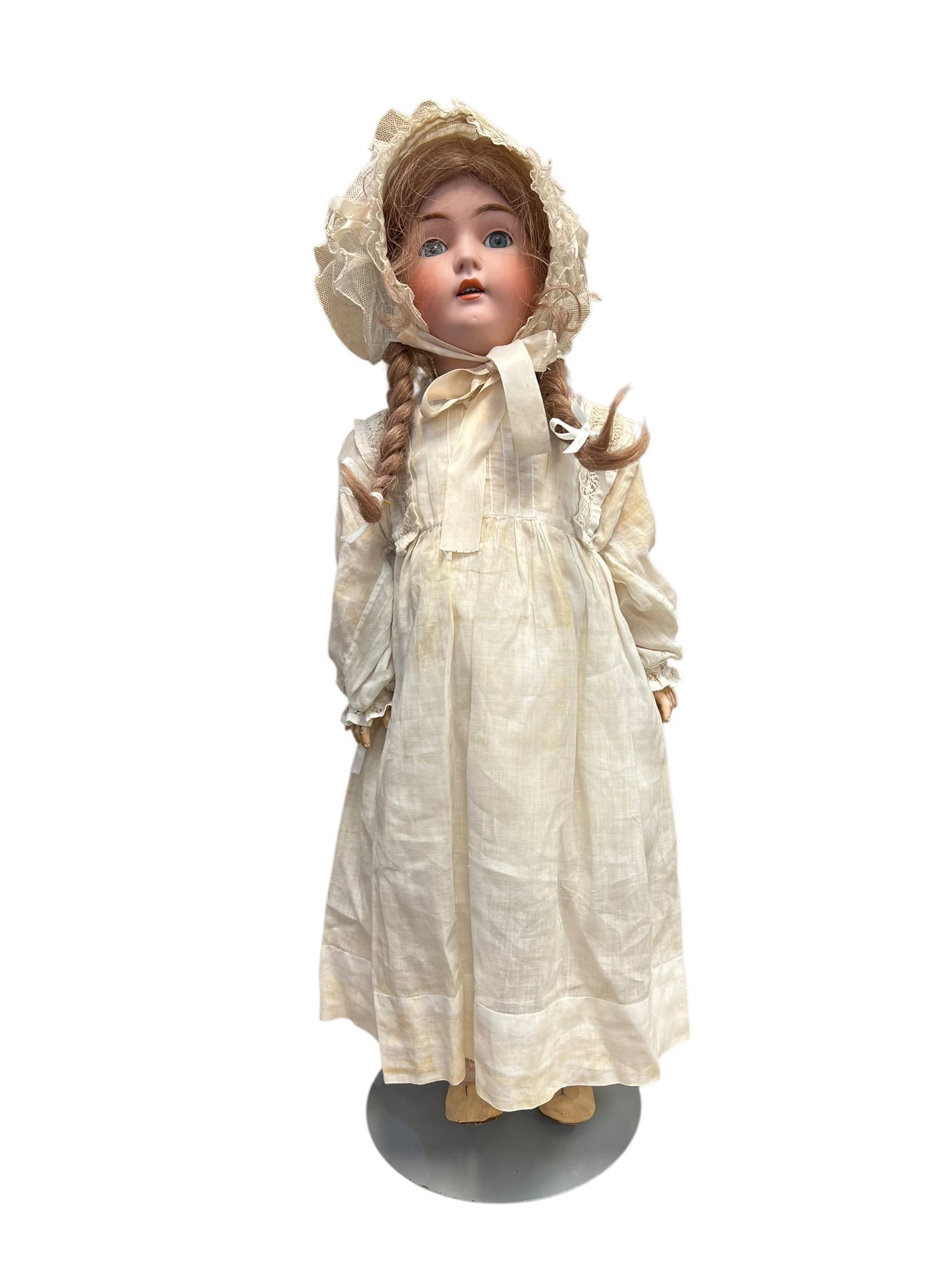 K 14 171 Germany Porcelain Doll: antique German bisque socket-head doll, likely from a maker such as Heinrich Handwerck or Simon & Halbig, featuring painted features, braided hair, a lace bonnet, and a period-style white dress