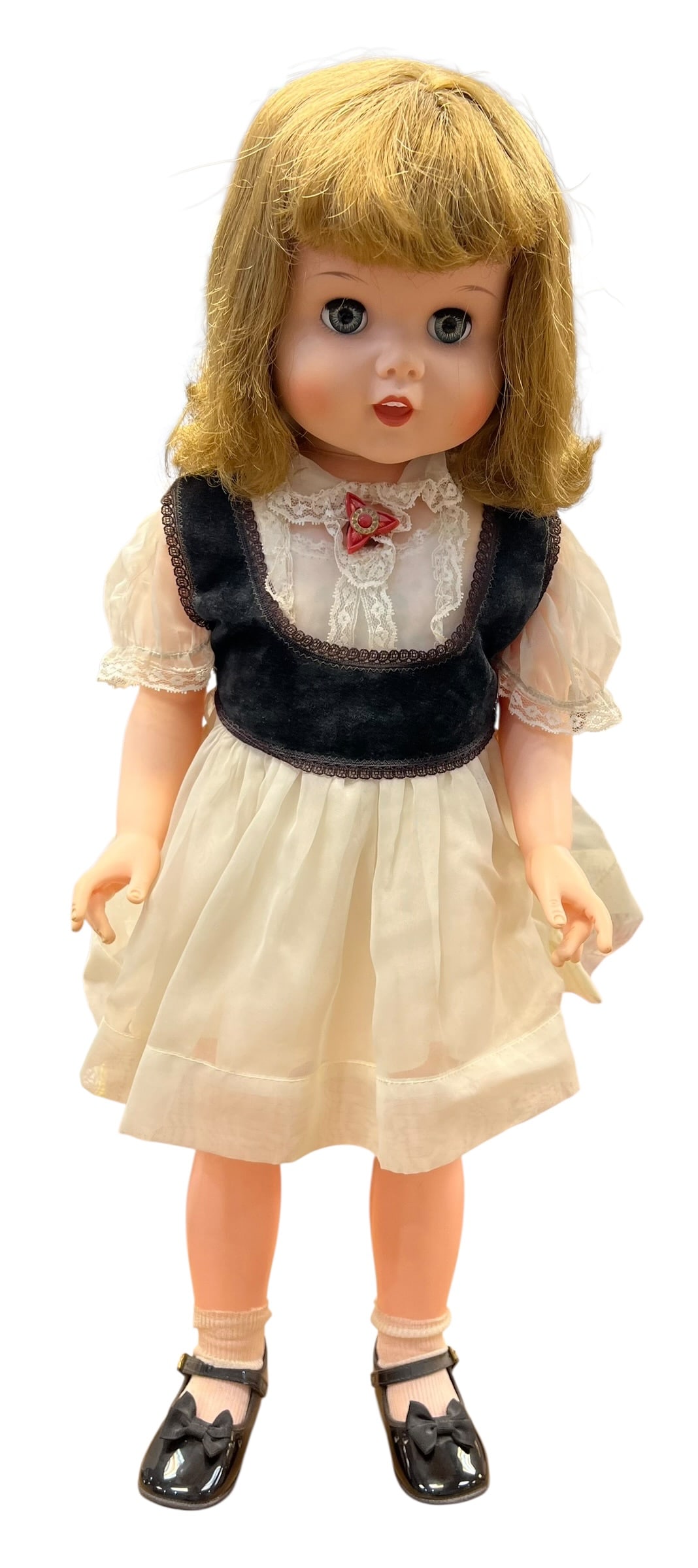 Vintage Madame Alexander-Style Blonde Girl Doll – Sleep Eyes, Original-Style Dress & Black Mary: Charming vintage girl doll featuring a hard plastic/vinyl construction, blonde shoulder-length wig with curled ends and bangs, large blue-gray sleep-style eyes, painted lashes and brows, rosy cheeks, 