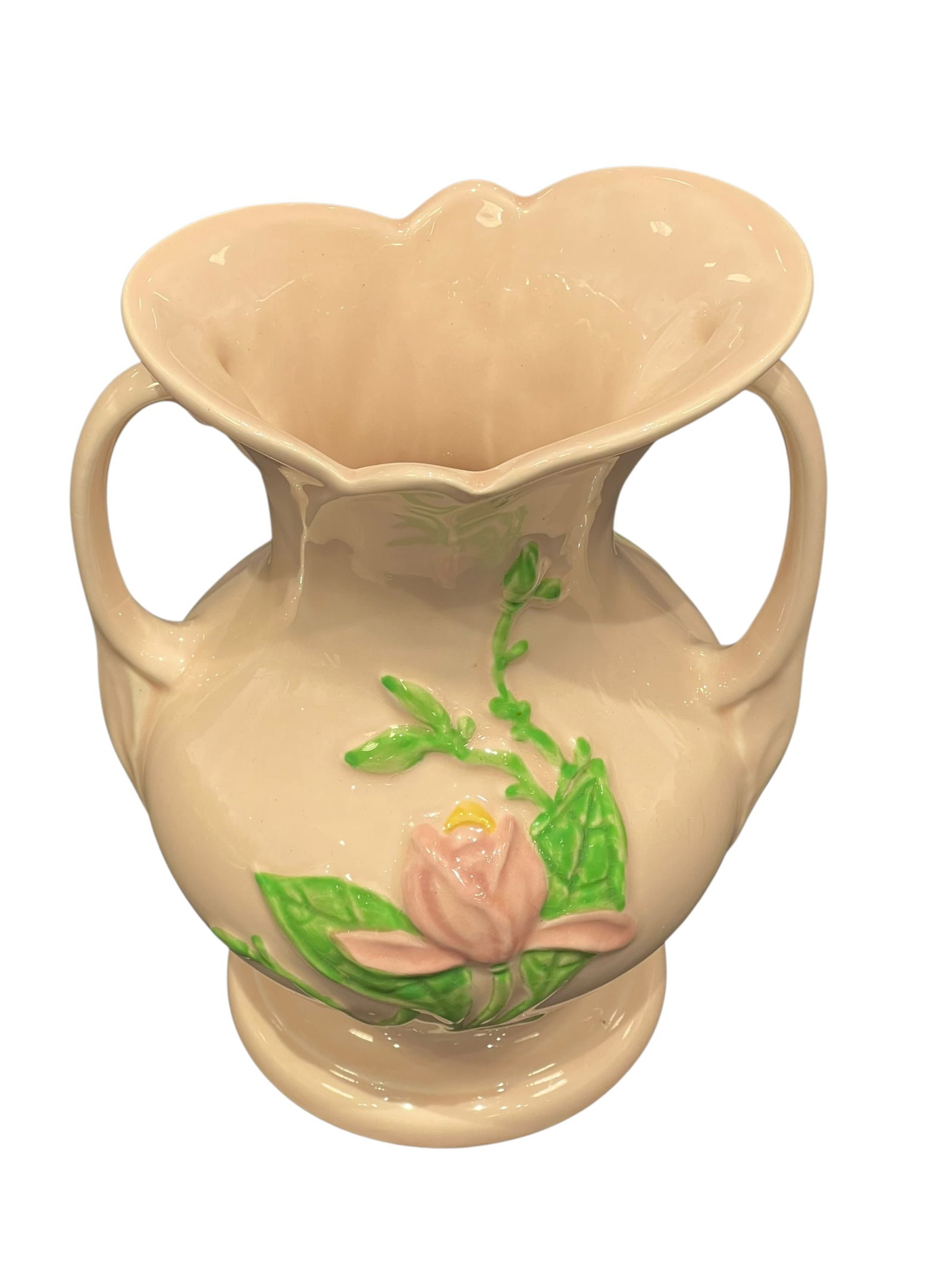 Hull Art Pottery Magnolia Double-Handled Vase, U.S.A.: Vintage Hull Art Pottery double-handled vase featuring a soft blush-pink/cream glazed body decorated with raised pink magnolia blossoms, buds and green leaves. The vase has a rounded body, pedestal fo