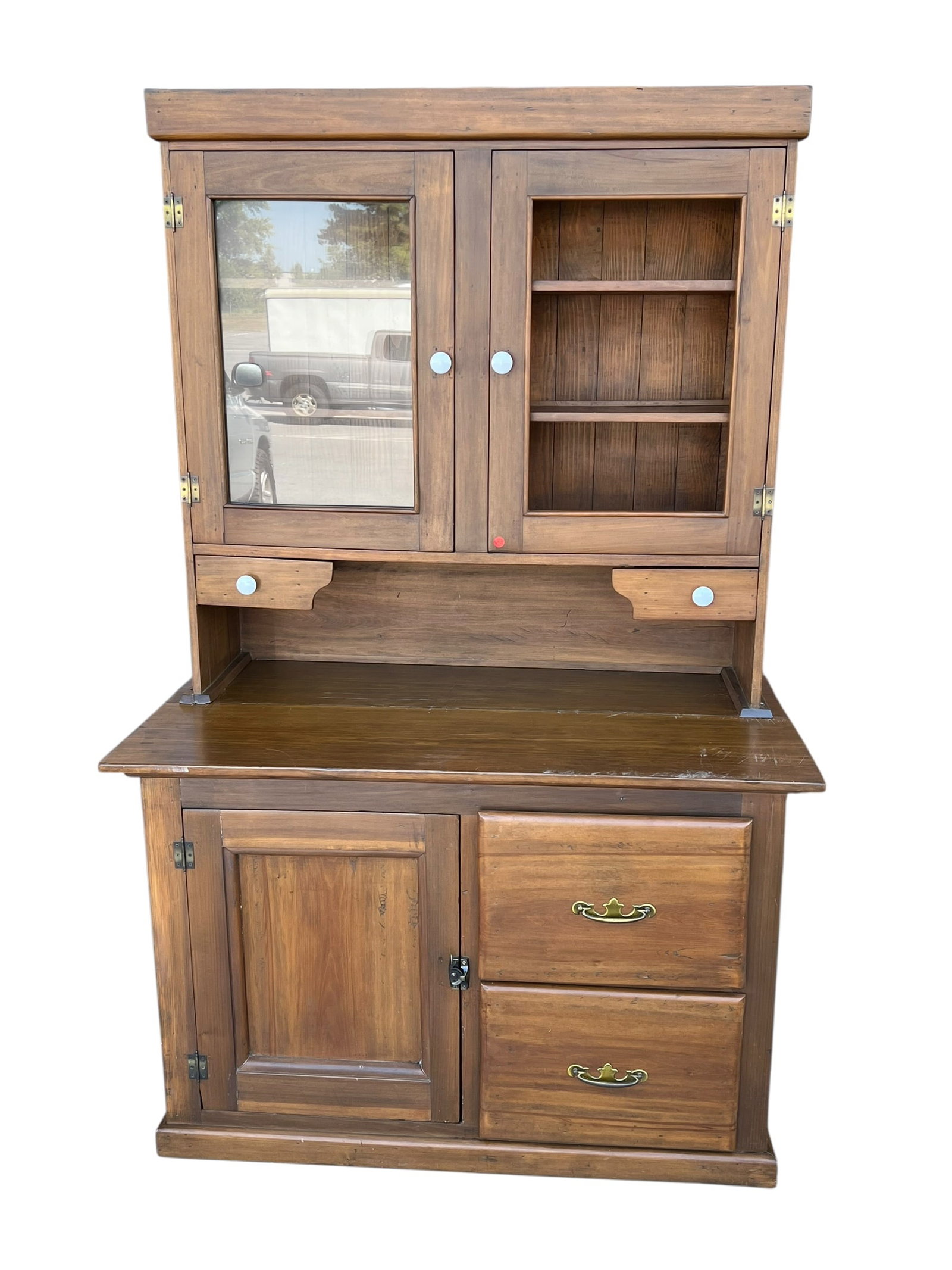 Antique Country Store / Farmhouse Step-Back Cupboard with Glass Door & Drawers: Large antique-style two-piece step-back cupboard / kitchen hutch in a warm natural wood finish. The upper section features two framed doors, one retaining a glass panel, with shelved storage behind, v