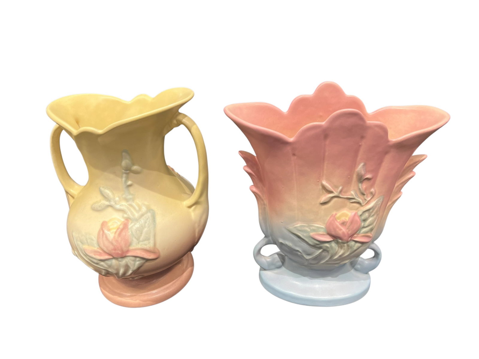 Pair of Vintage Hull Art Pottery Magnolia Vases – Pastel Glaze: Pair of vintage Hull Art pottery vases featuring the classic raised Magnolia floral pattern and soft pastel matte glazes associated with mid-century Hull pottery.The first is a double-handled urn-form