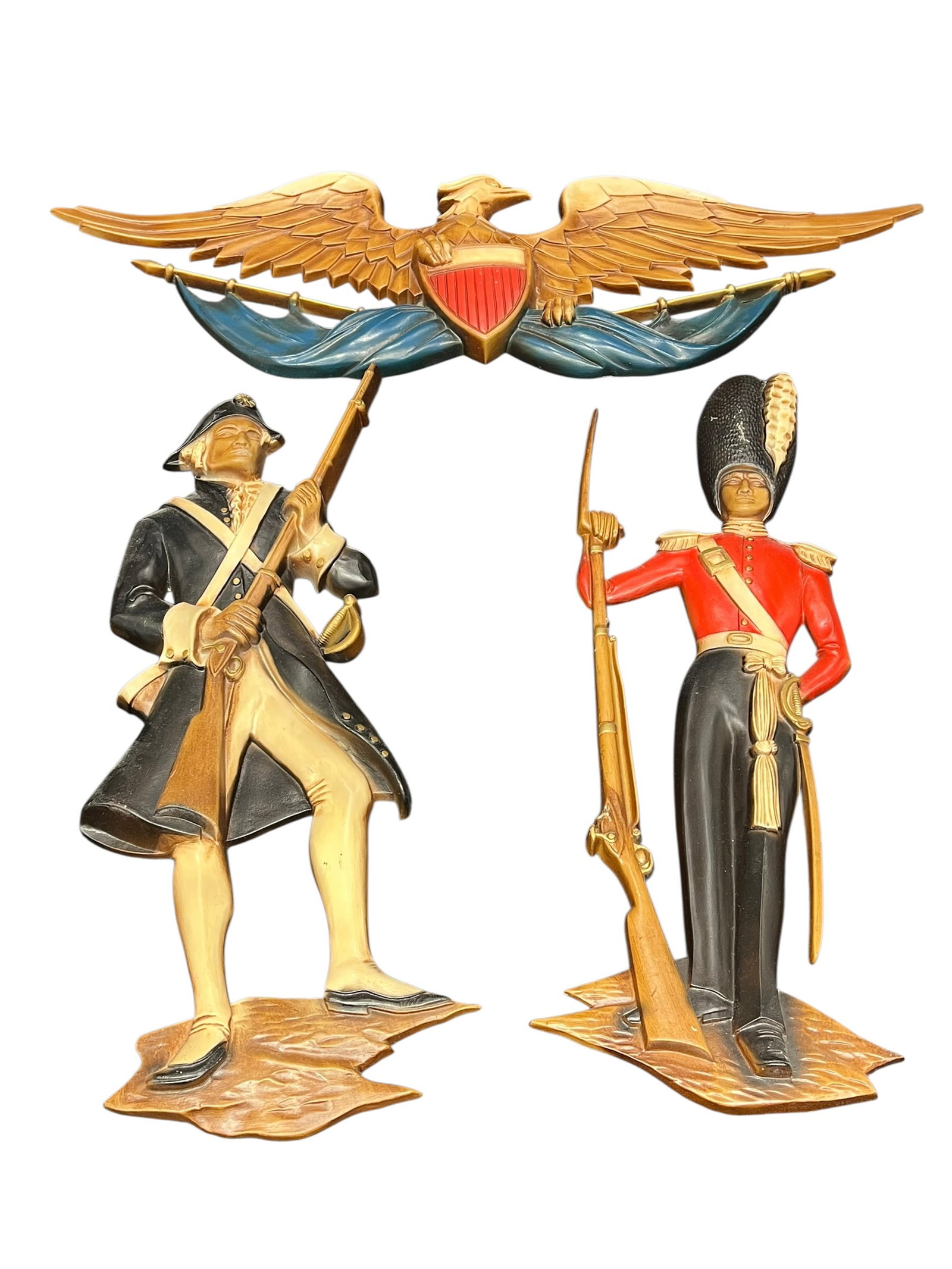 Vintage Sexton Cast Metal Military Wall Plaques – Revolutionary War & British Guard, Eagle Emblem: Group of three vintage Sexton cast metal wall plaques with military and patriotic themes. The set includes a Revolutionary War-era American soldier carrying a long rifle and wearing a tricorn hat, a B