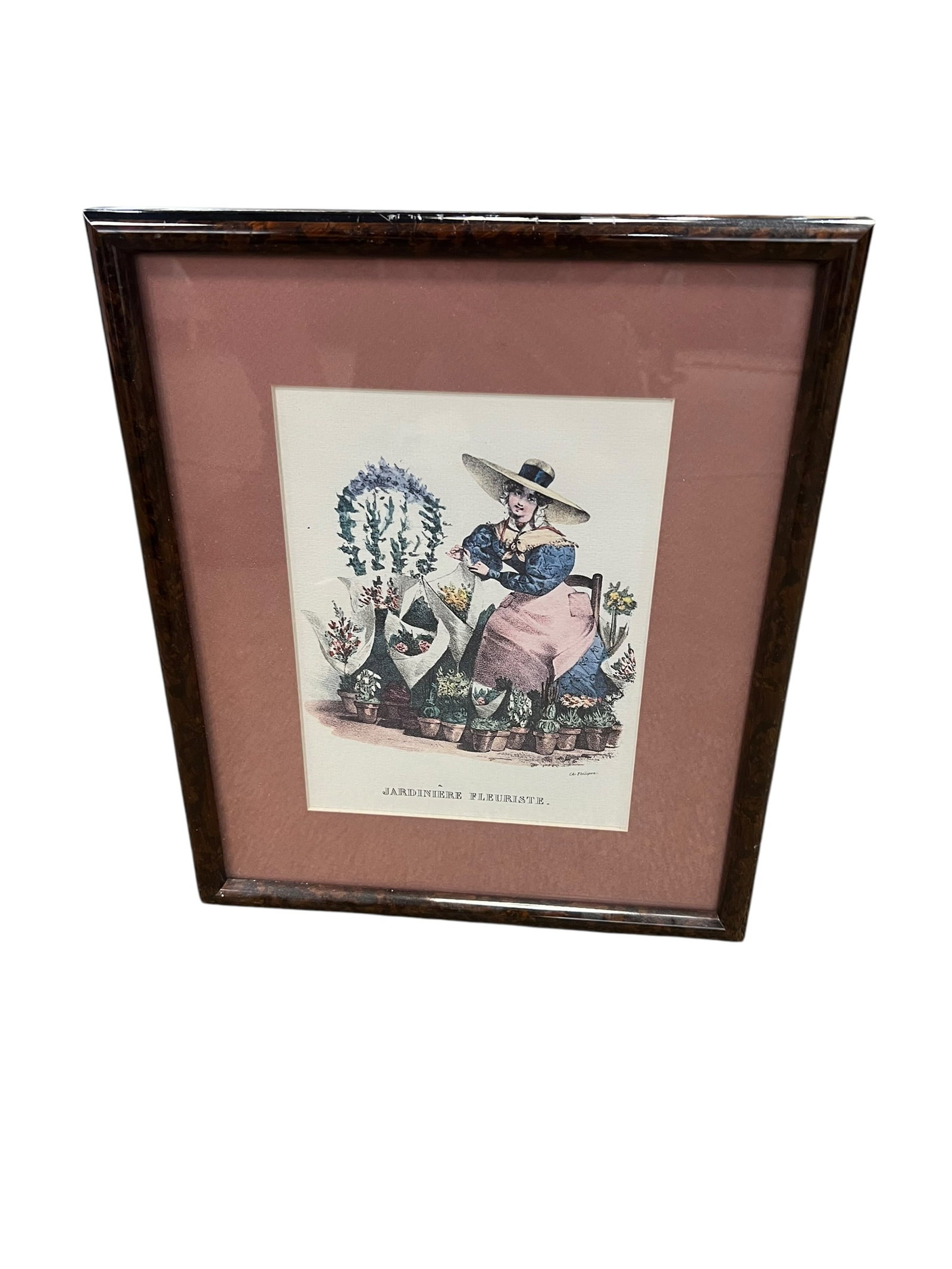 “Jardinière Fleuriste” French Flower Seller Hand-Colored Fashion Print, Framed: Charming framed French-style hand-colored fashion and occupational print titled “Jardinière Fleuriste”, depicting a fashionable young flower seller or gardener seated among an assortment of p