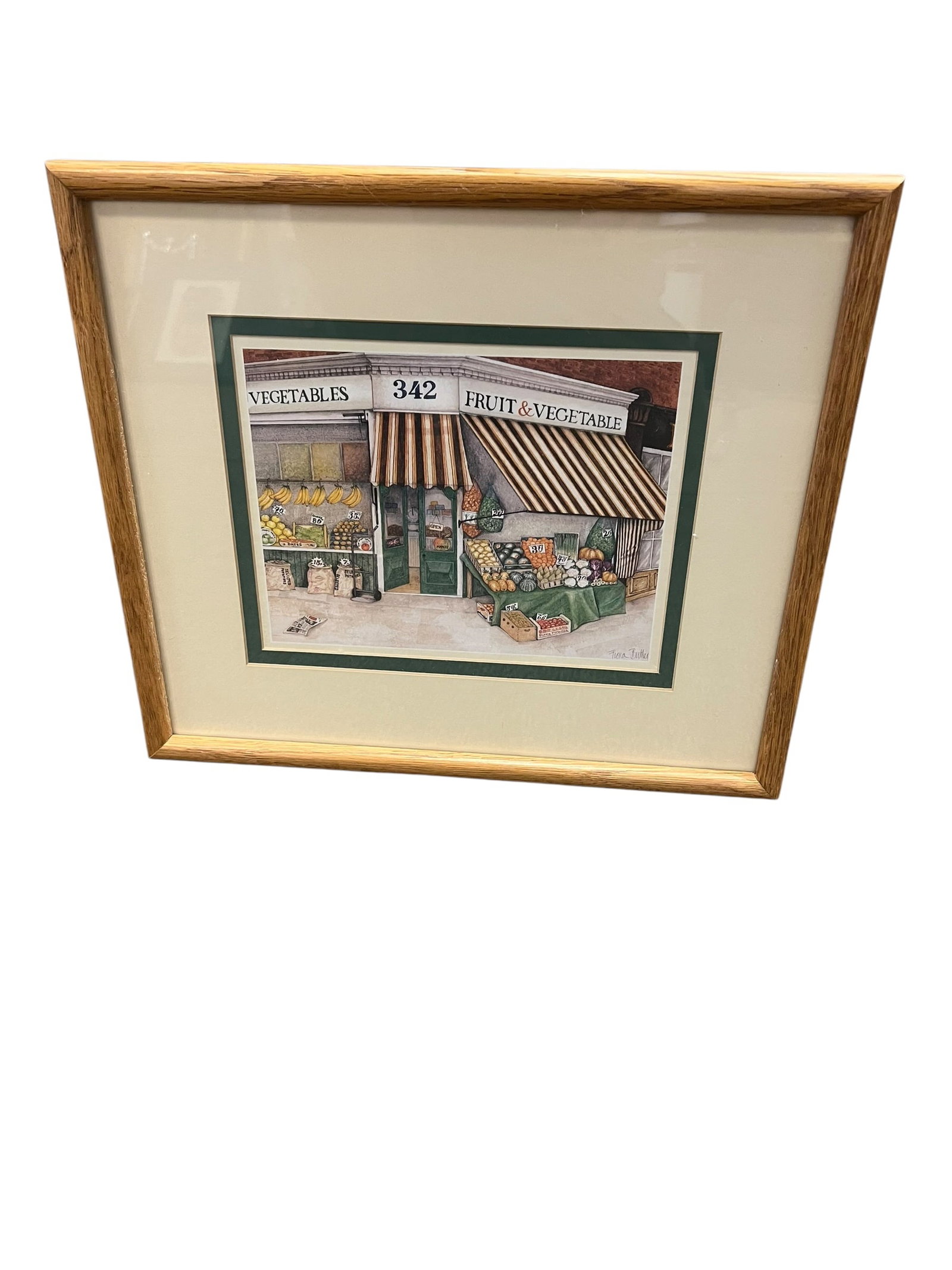 Signed Flora Rutter Fruit & Vegetable Market Storefront Print – Framed: Charming framed artwork depicting a nostalgic neighborhood fruit and vegetable market storefront, numbered 342, with striped awnings and colorful displays of fresh produce arranged along the sidewalk.