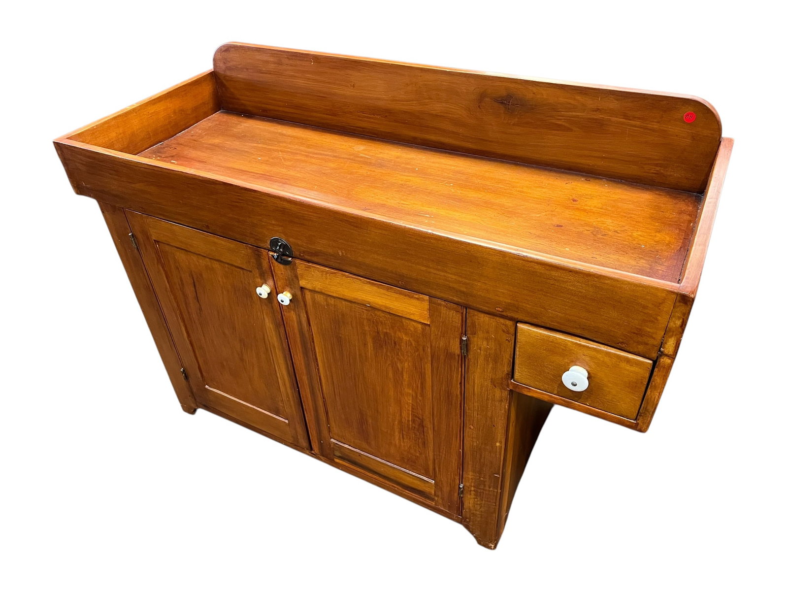 Antique Southern Country Store Dry Sink with Porcelain Knobs: Antique country dry sink constructed of solid wood with a warm honey-brown finish and appealing primitive character. Features a deep, gallery-style work surface surrounded by a tall rounded backsplash